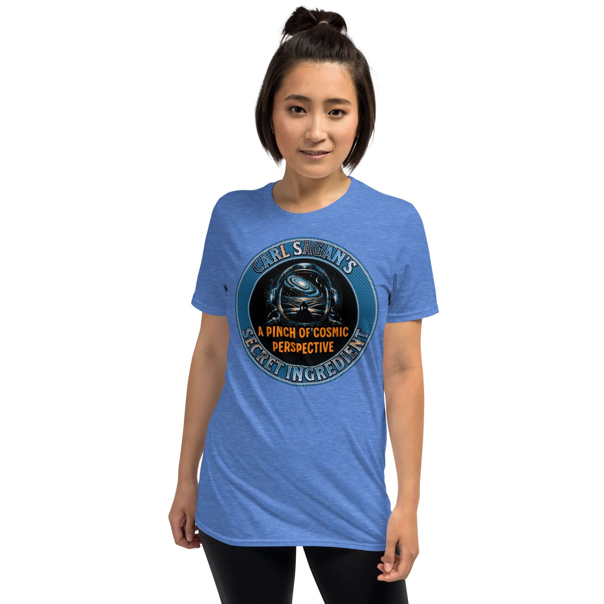Blue t-shirt with astronaut helmet and galaxy design, reading "Carl Sagan's Secret Ingredient: A Pinch of Cosmic Perspective.”
