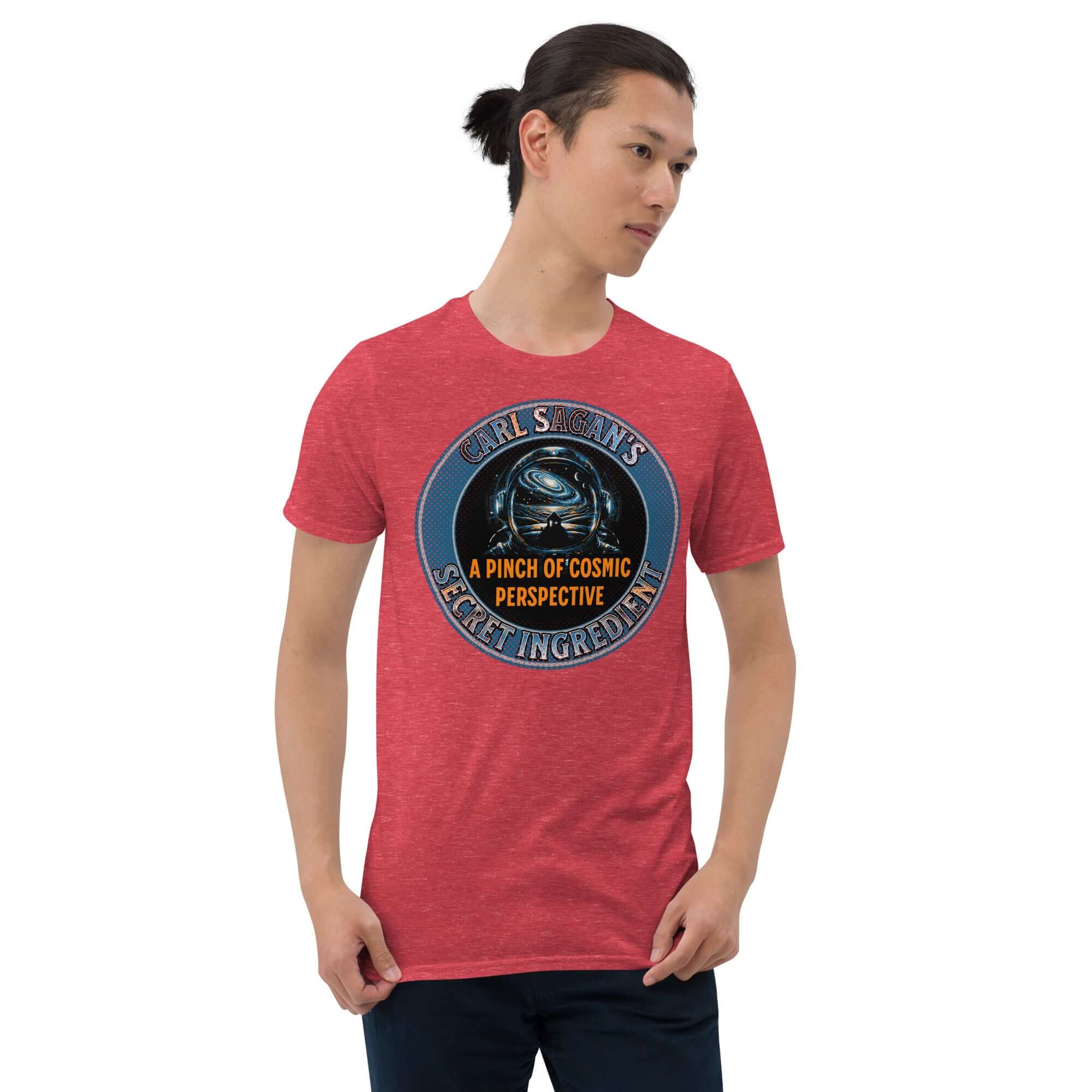 Man wearing Carl Sagan's Secret Ingredient T-Shirt with astronaut helmet and galaxy design, text: A Pinch of Cosmic Perspective.