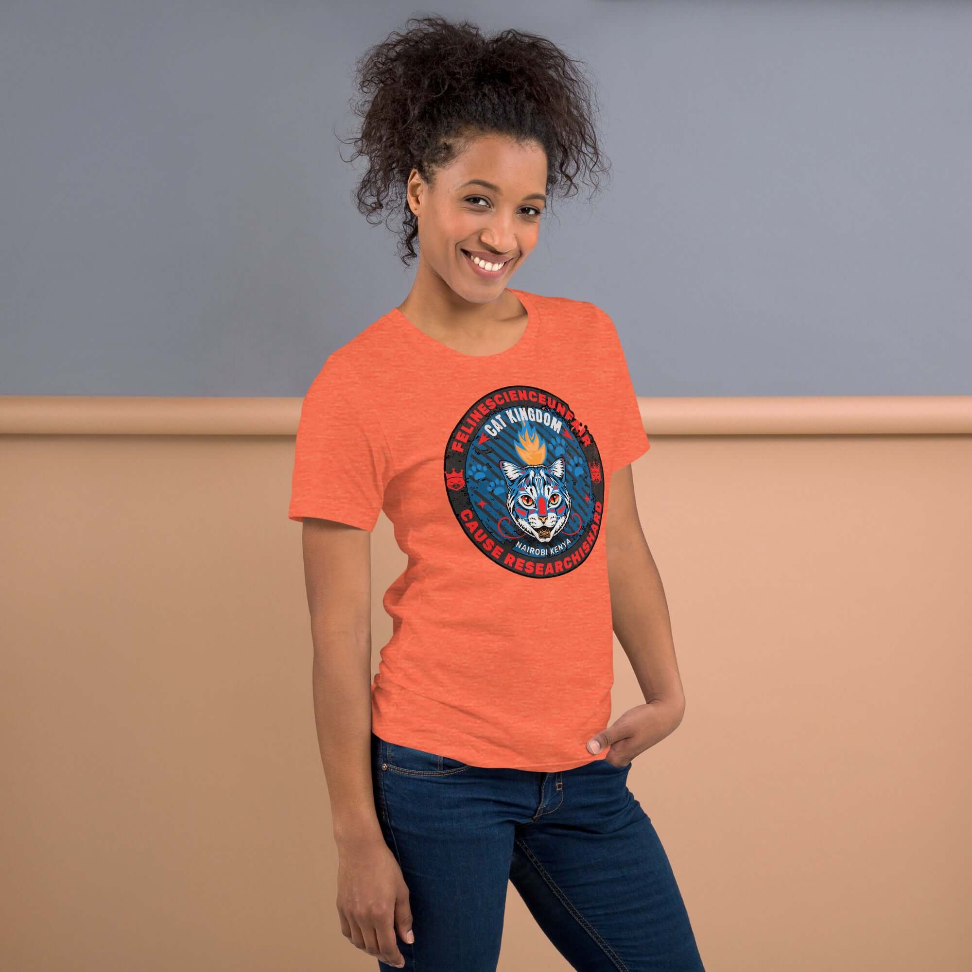 Woman wearing orange Feline Science Unit Cat Kingdom T-Shirt featuring a wildcat design, ideal for researchers or cat enthusiasts.