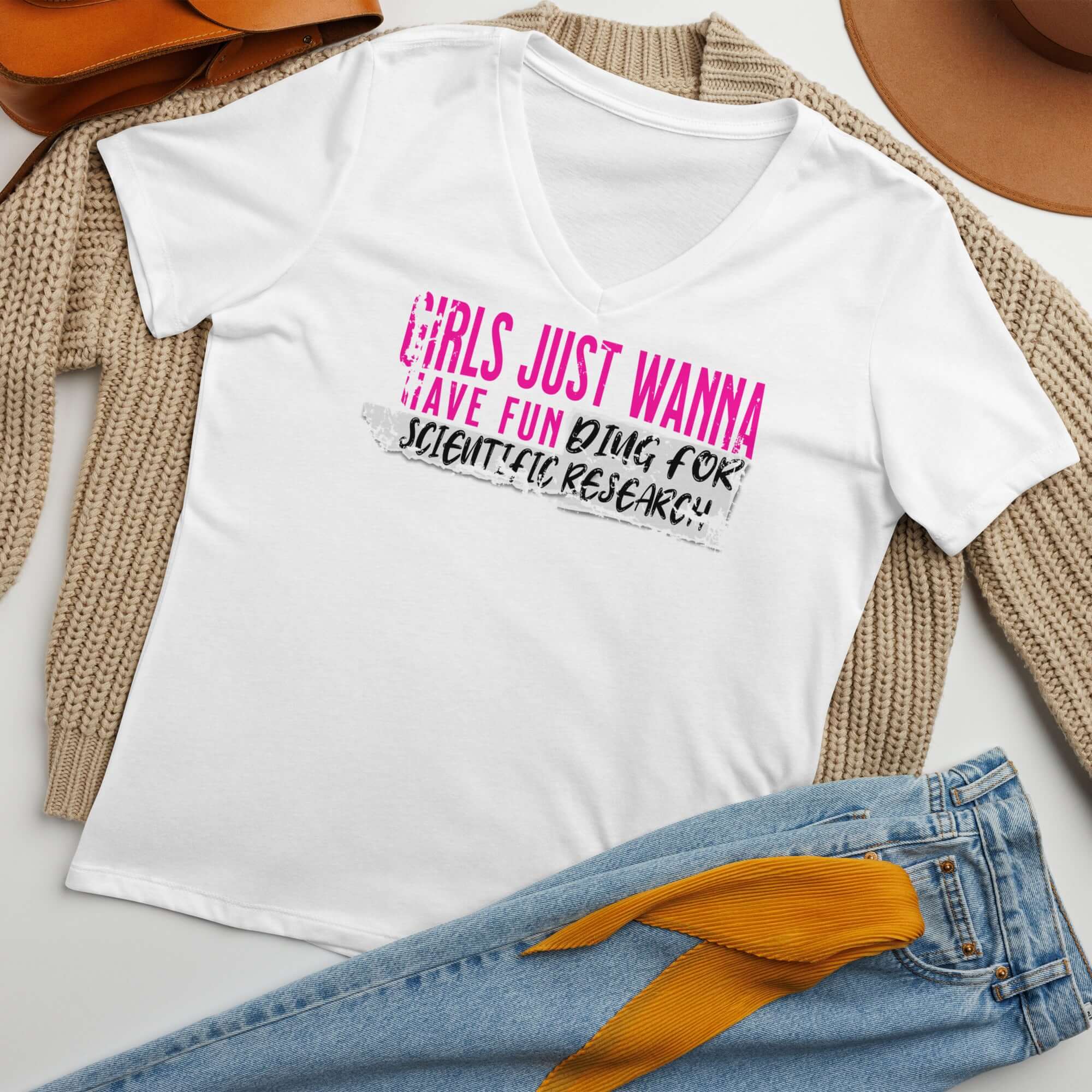 Girls Just Wanna Have Fun Doing Scientific Research T-shirt with pink and black text on a laid-back casual outfit.