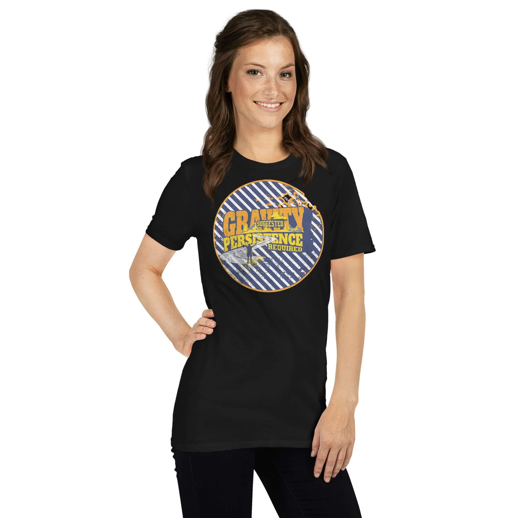 Model wearing Gravity Suggested Persistence Required t-shirt with navy and white stripes, gold-yellow typography, motivational apparel.