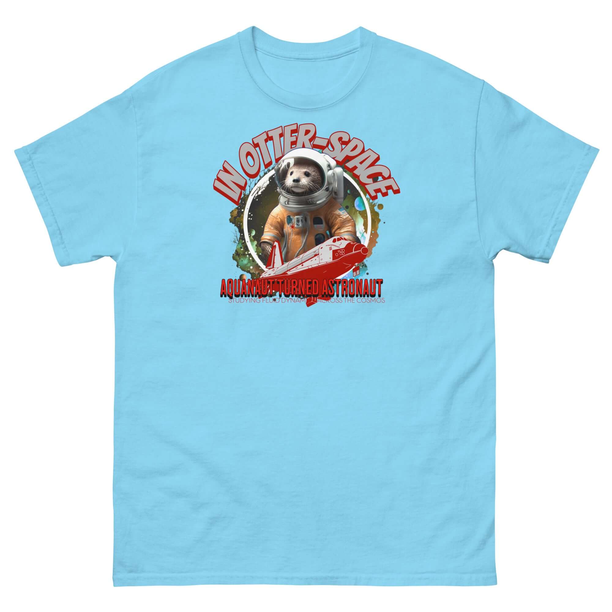 Blue t-shirt featuring an otter in an astronaut suit, space shuttle, and text 'In Otter Space: Aquanaut Turned Astronaut' on cosmic backdrop.