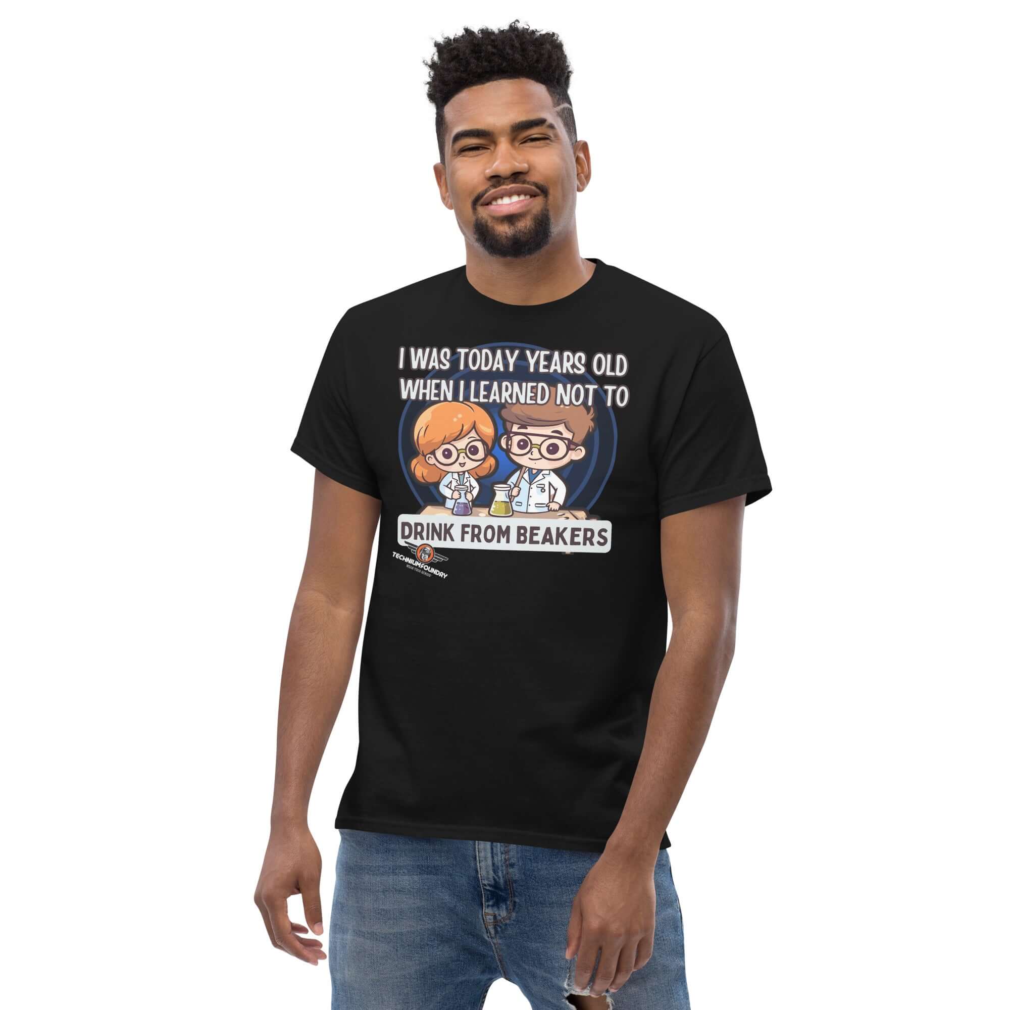 Man wearing 'I Was Today Years Old' black t-shirt featuring chibi scientists with a lab safety message about not drinking from beakers.