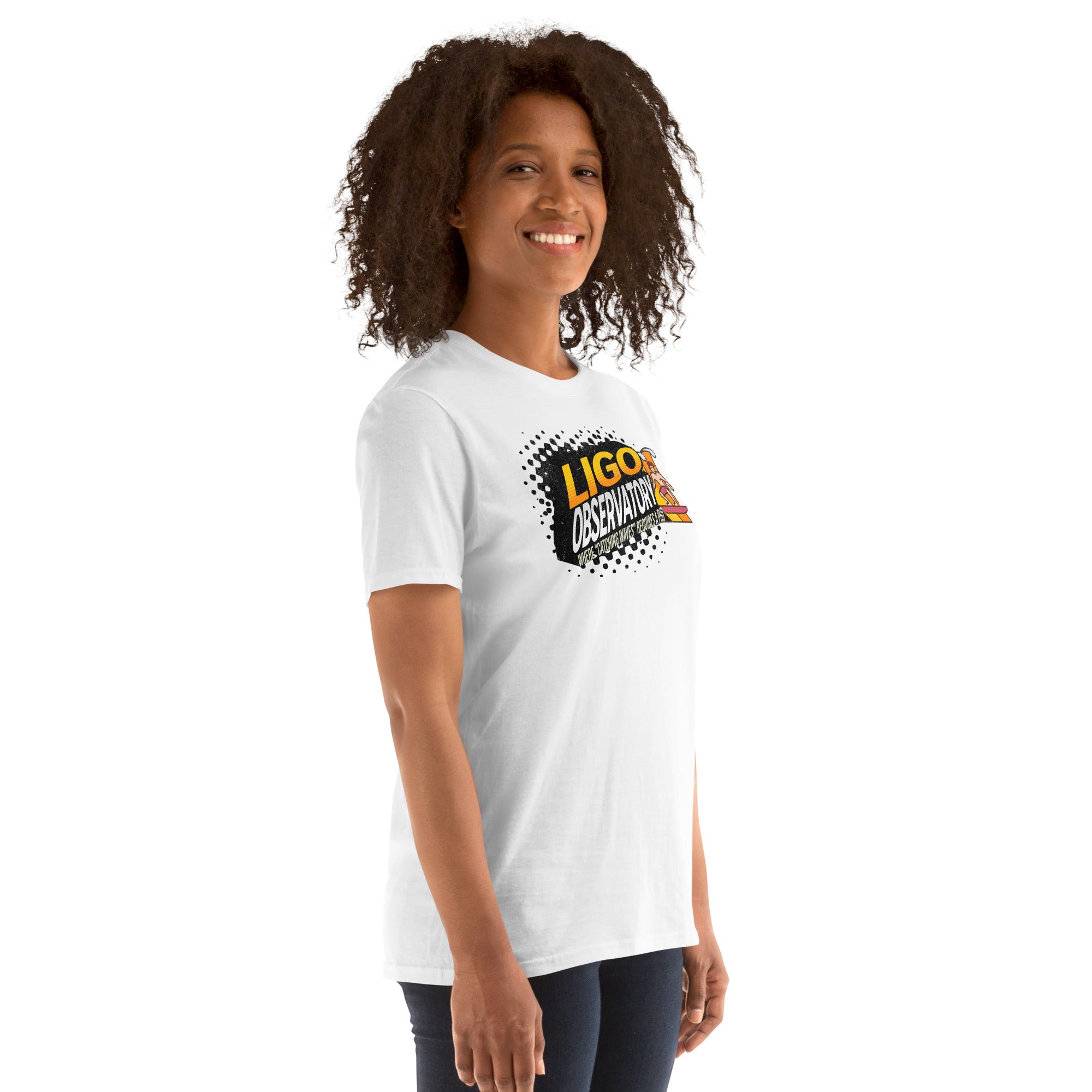Woman wearing a LIGO Observatory T-Shirt featuring vibrant gradient lettering on a charcoal background. "Catching Waves" text included.