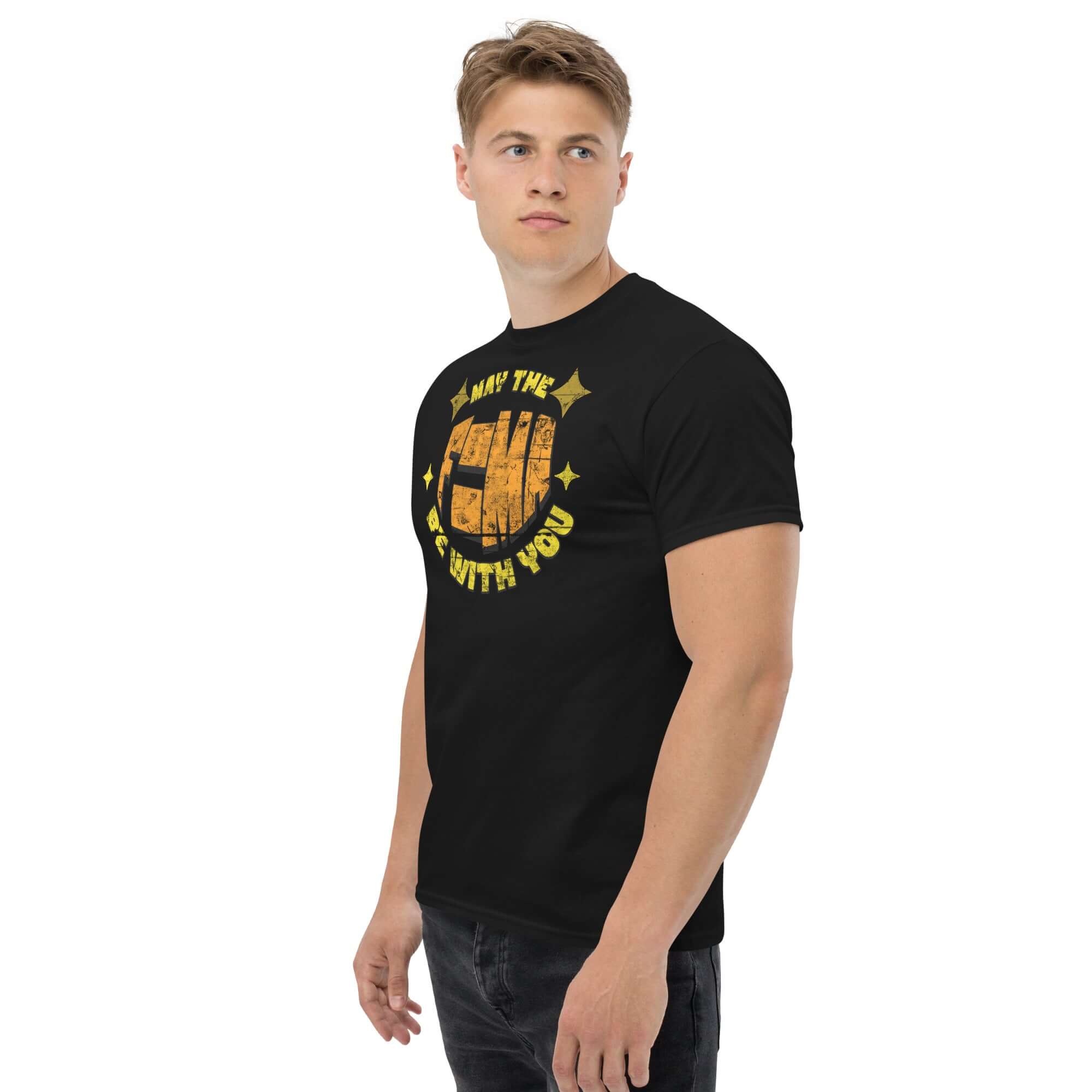 Black "May The F=MA Be With You" t-shirt featuring physics and sci-fi parody design worn by male model.