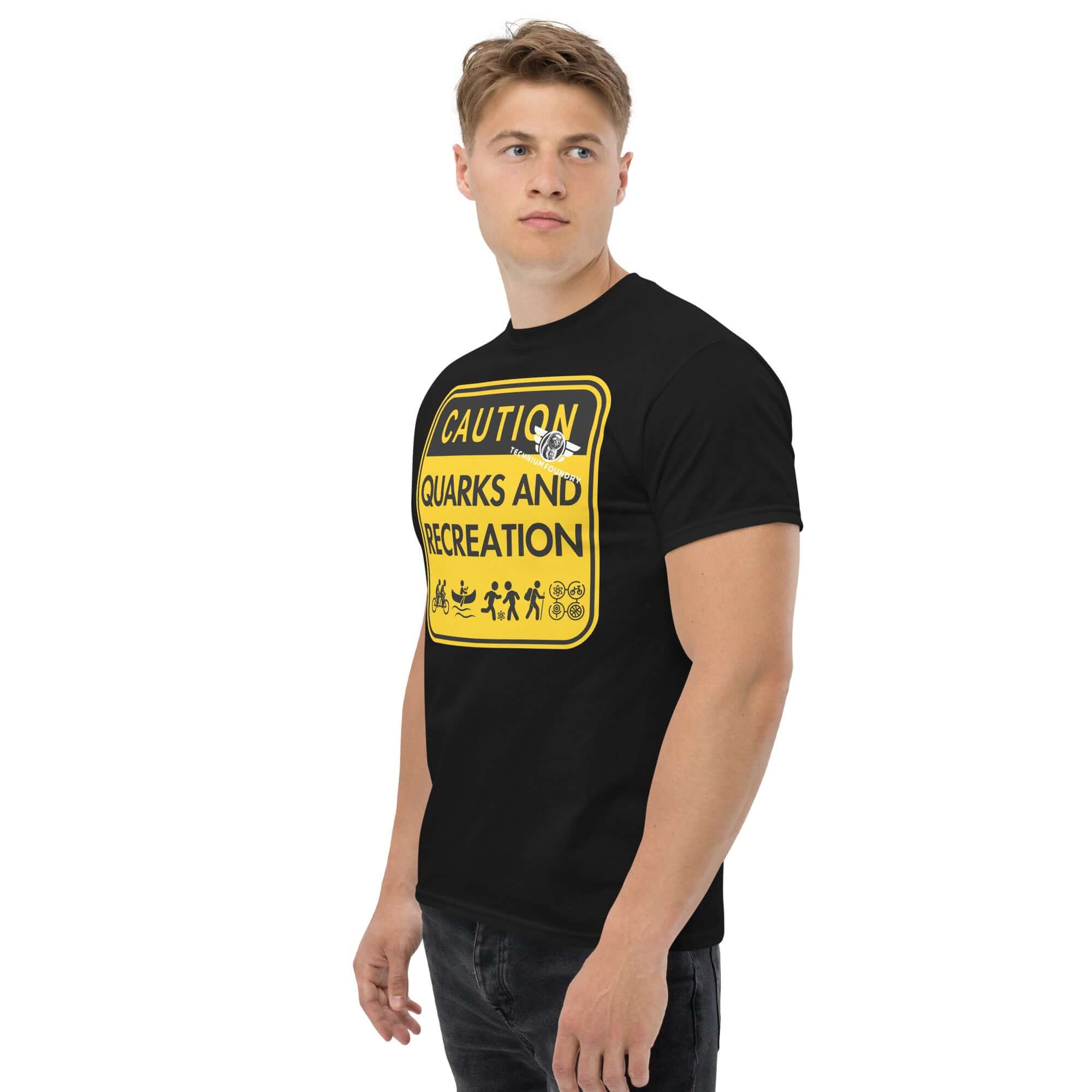 Man wearing humorous 'Quarks and Recreation' t-shirt with particle physics warning sign design in yellow and black.