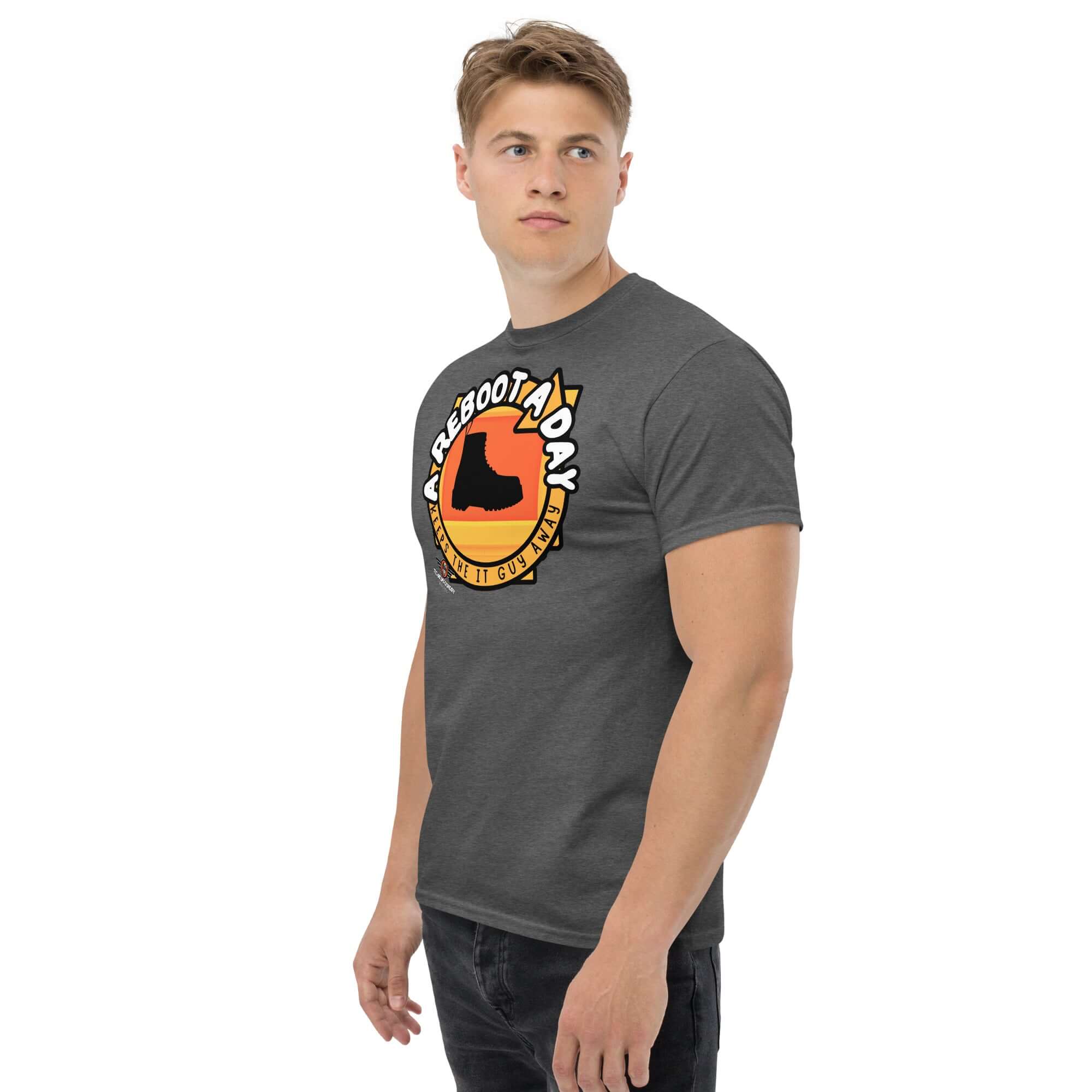 Man wearing 'A Reboot A Day' IT support humor t-shirt with combat boot design on grey background.