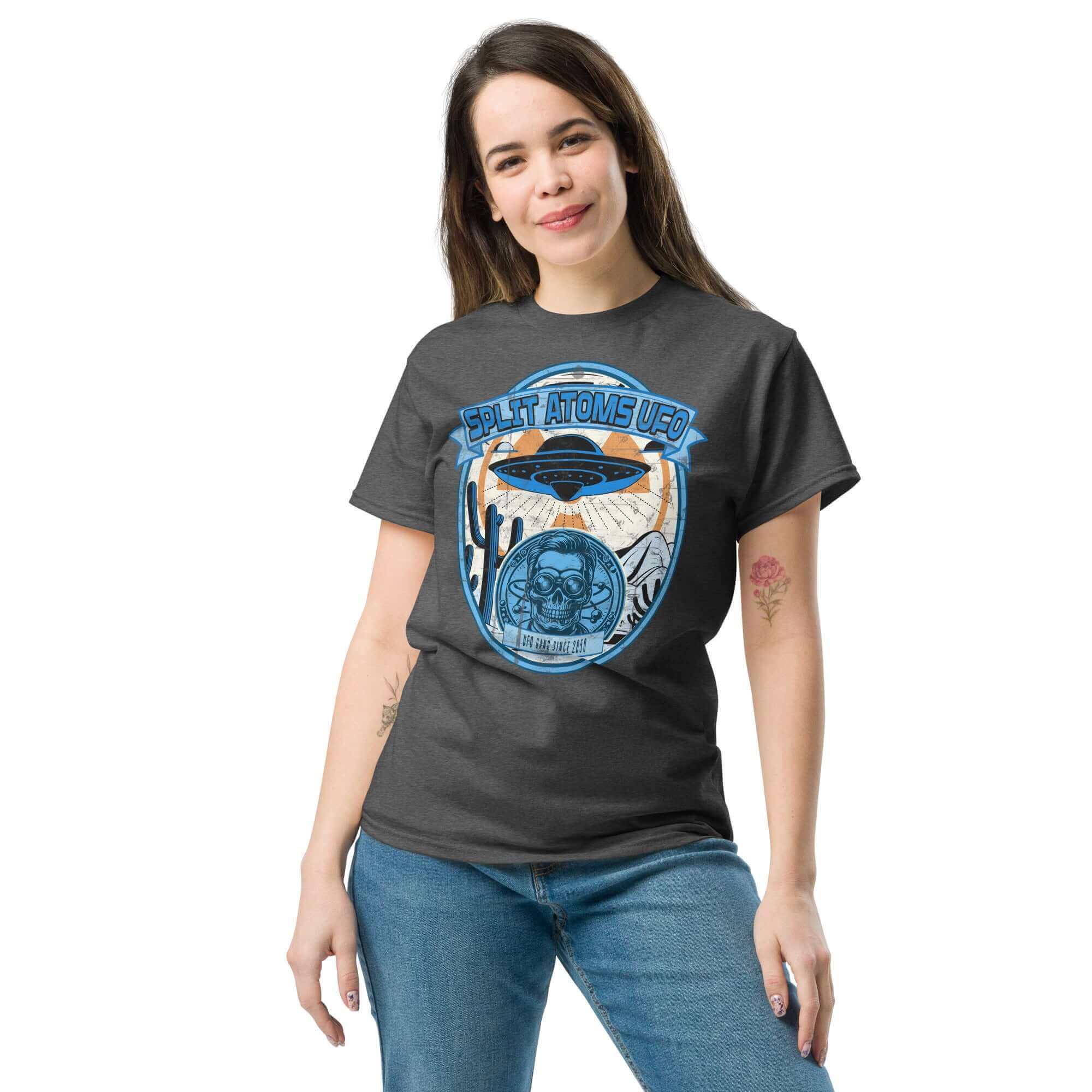 Woman wearing Split Atoms UFO Gang T-Shirt with retro alien desert design, featuring a flying saucer above a scenic desert landscape.