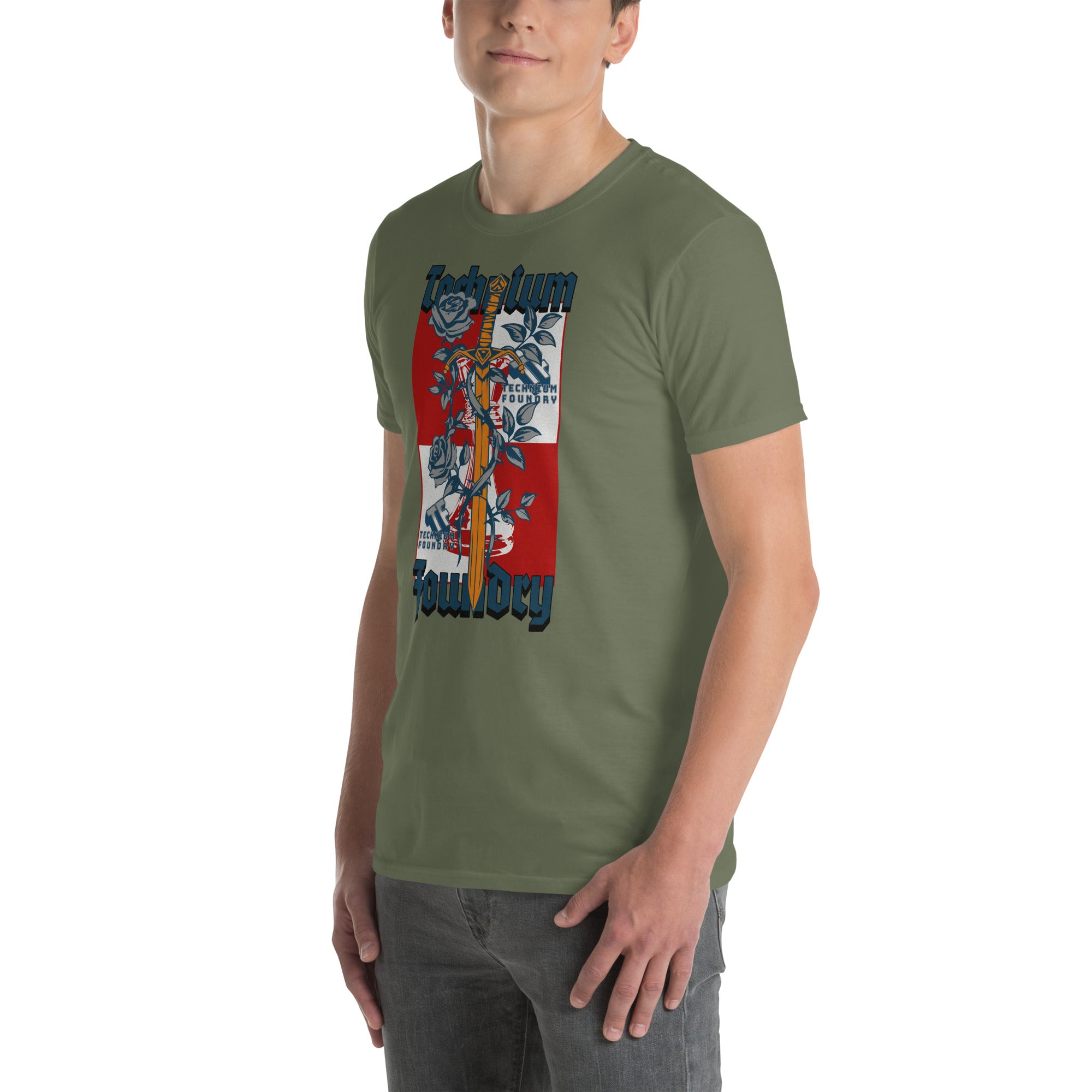 Man wearing olive green Technium Foundry Logo T-Shirt with vibrant orange emblem and intellectual design.