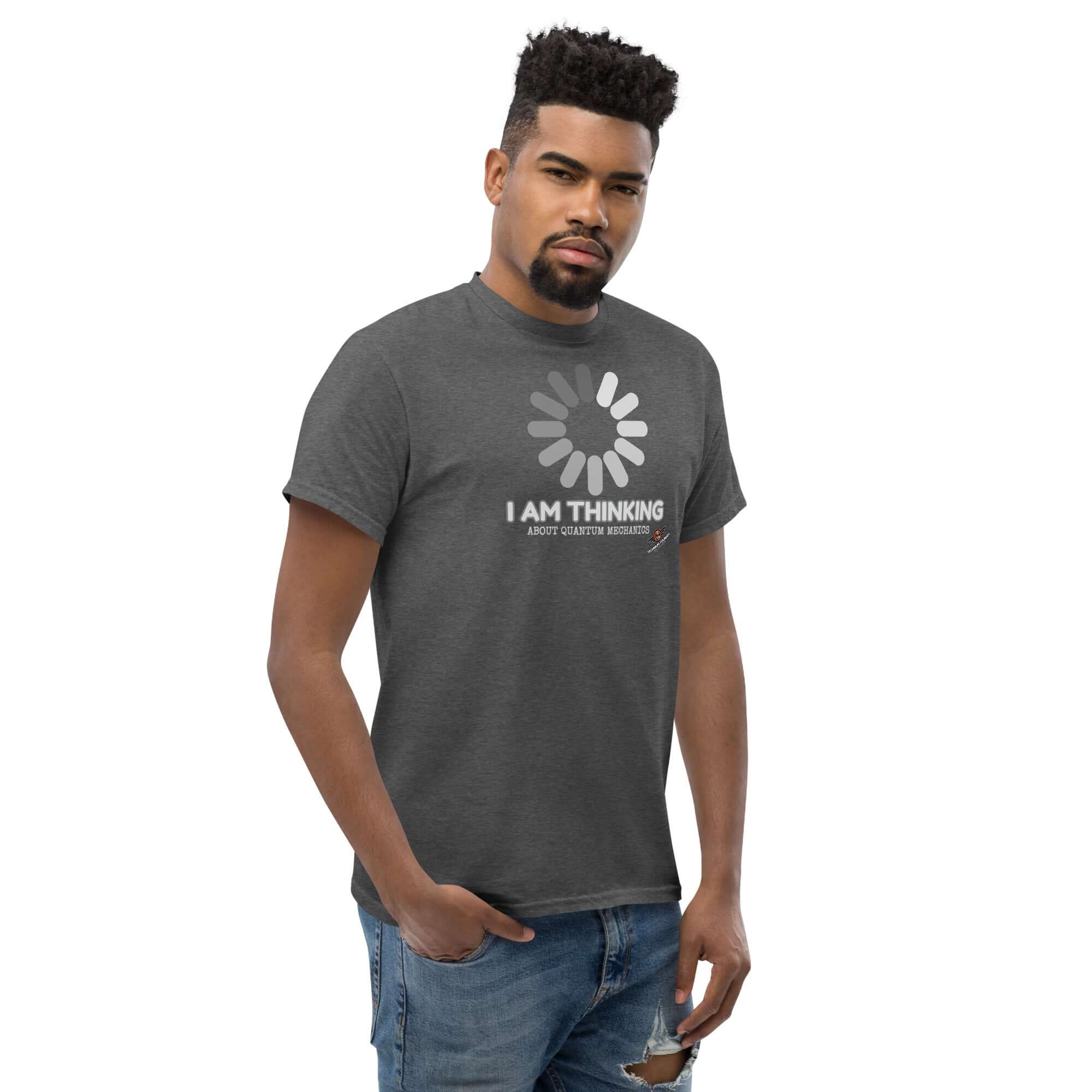 Man wearing 'I Am Thinking About Quantum Mechanics' loading screen t-shirt, highlighting Schrödinger's Buffer and wave-particle duality theme.