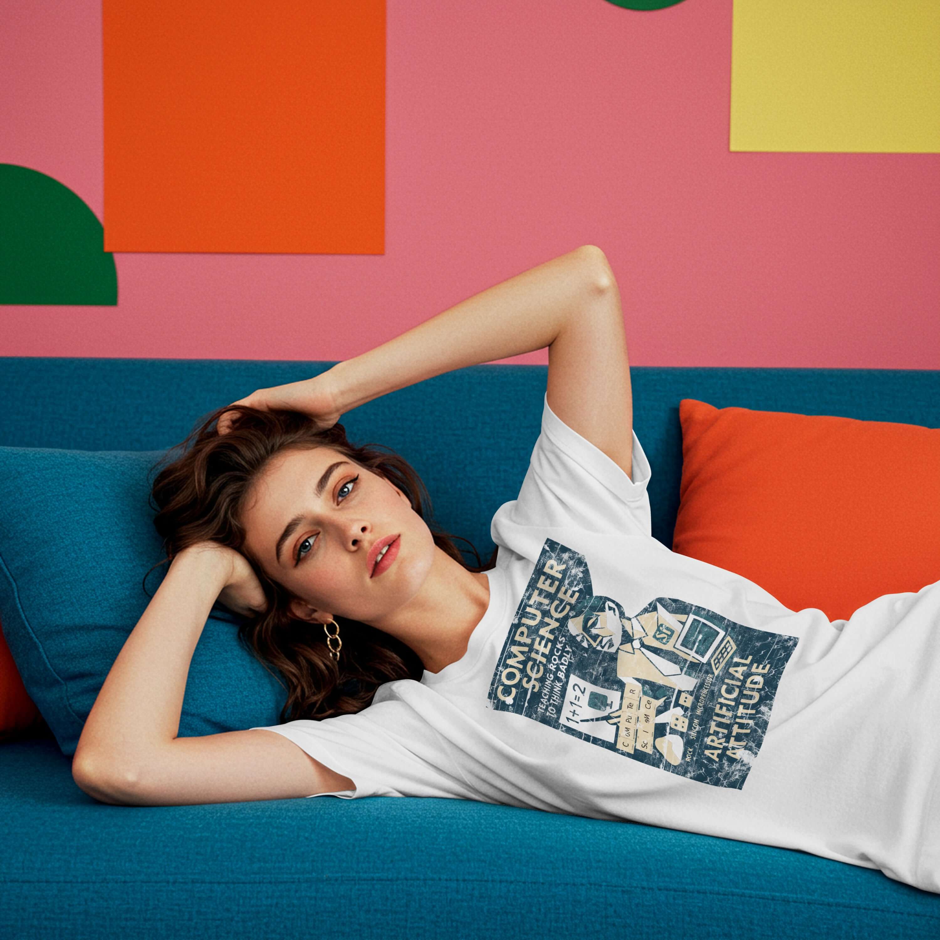 Woman wearing a "Computer Science: Teaching Rocks to Think Badly" T-shirt, lying on a colorful couch in a vibrant room.