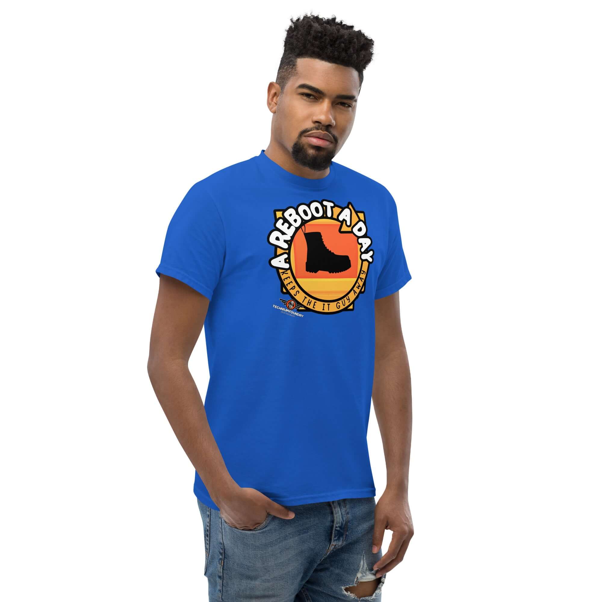 Person wearing 'A Reboot A Day' IT support humor t-shirt featuring boot design and sunset colors.