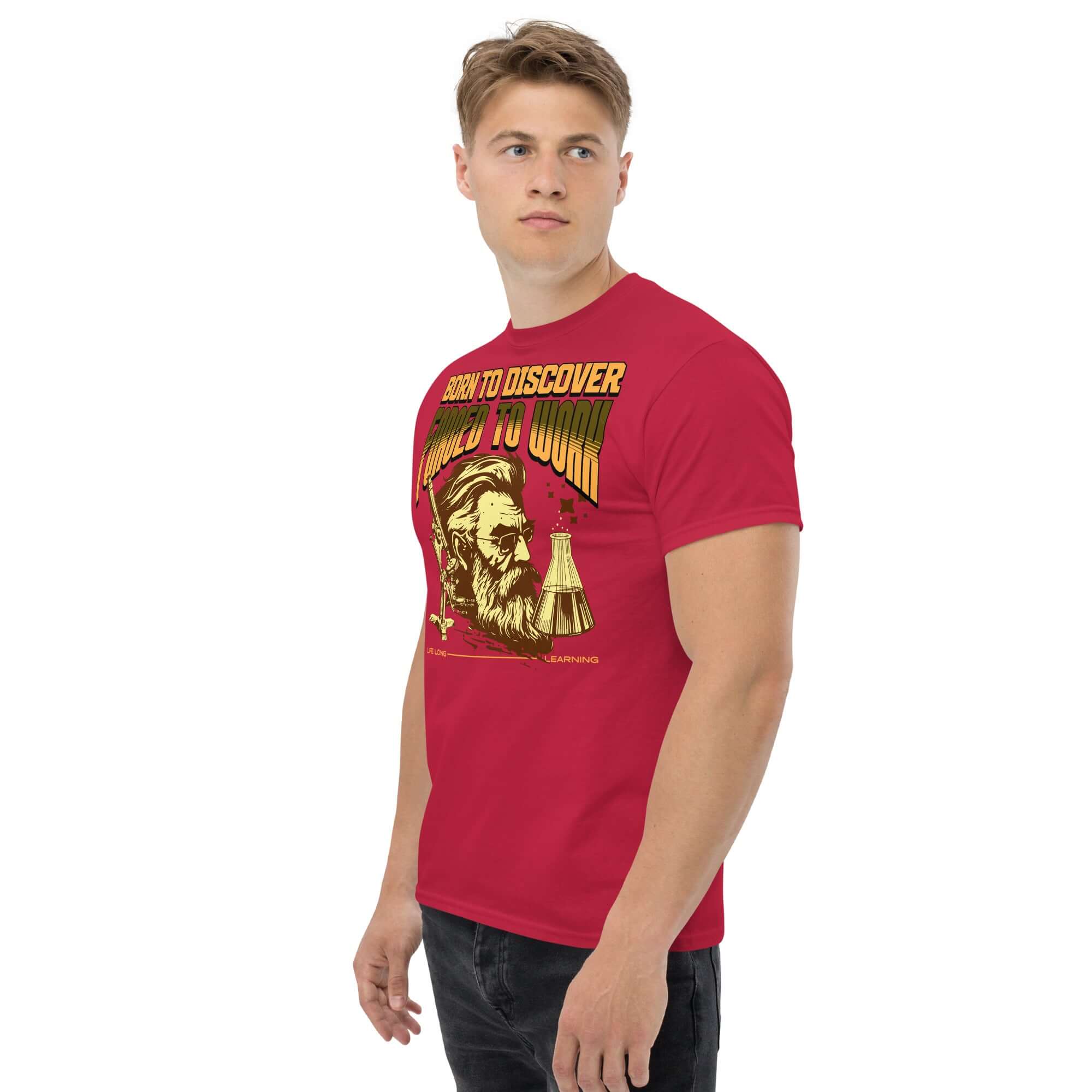 Red t-shirt with 'Born to Discover, Forced to Work' text and illustration of a bearded scientist, ideal for academics and science enthusiasts.