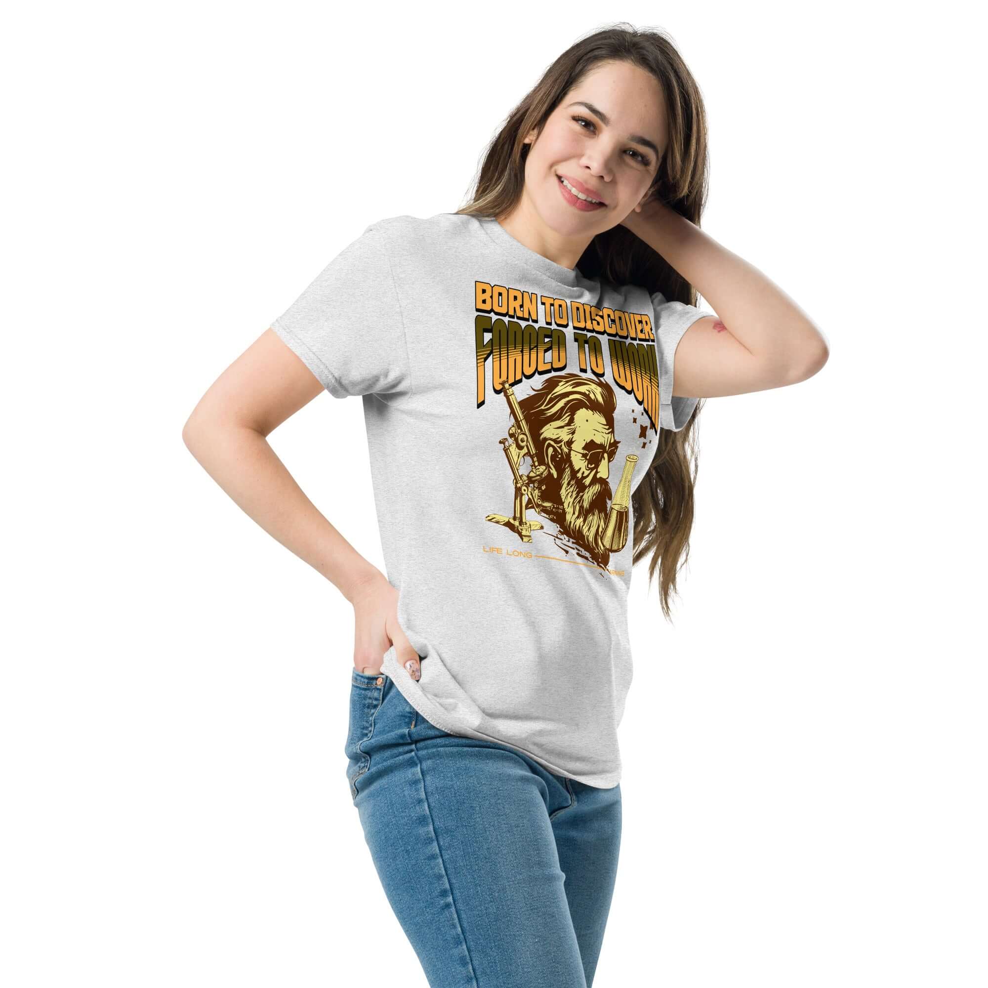 Woman wearing 'Born to Discover, Forced to Work' T-shirt with vintage scientist illustration, ideal for academics and science lovers.