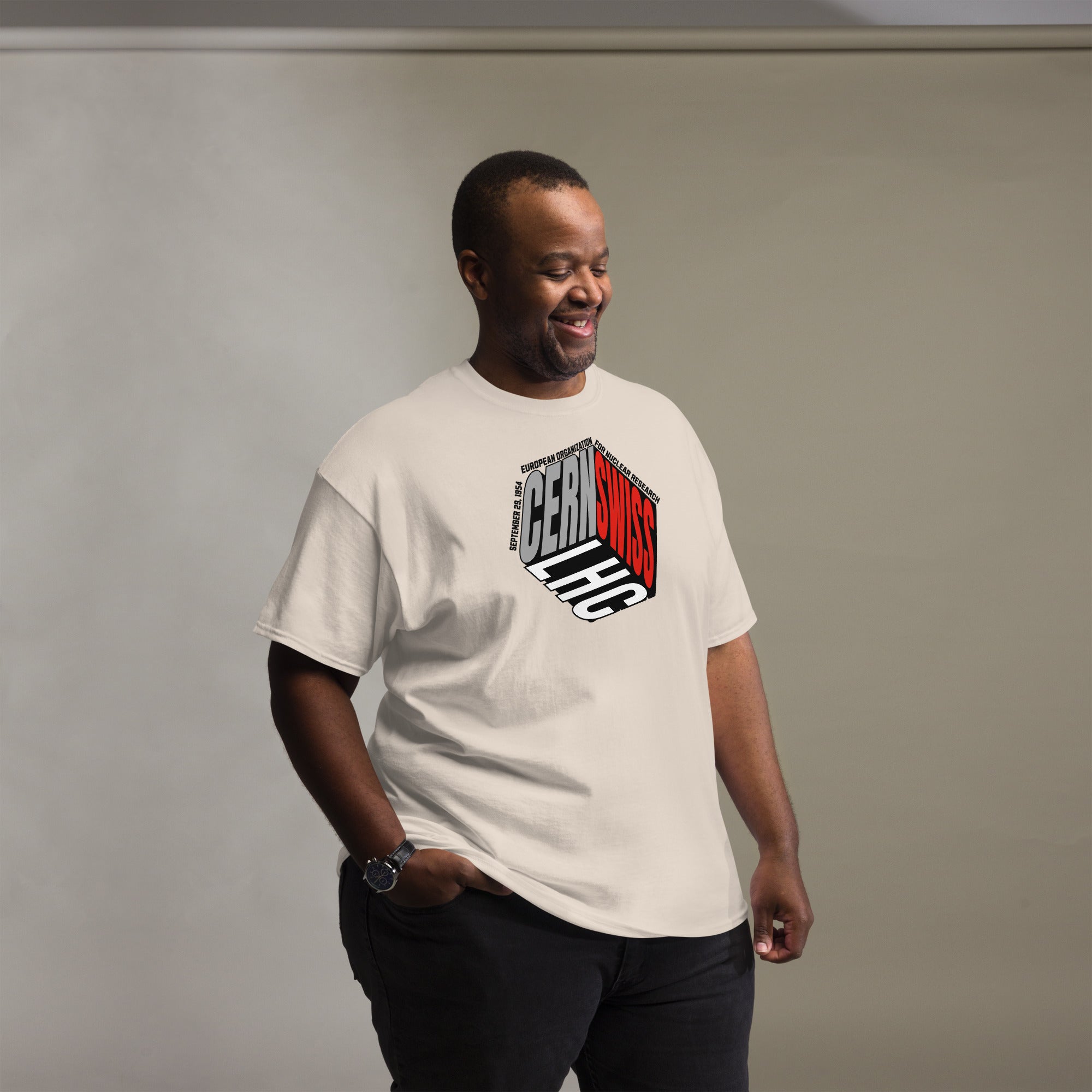 Man wearing a CERN/Swiss Physics Cube T-Shirt featuring a unique physics-inspired design, showcasing scientific style.