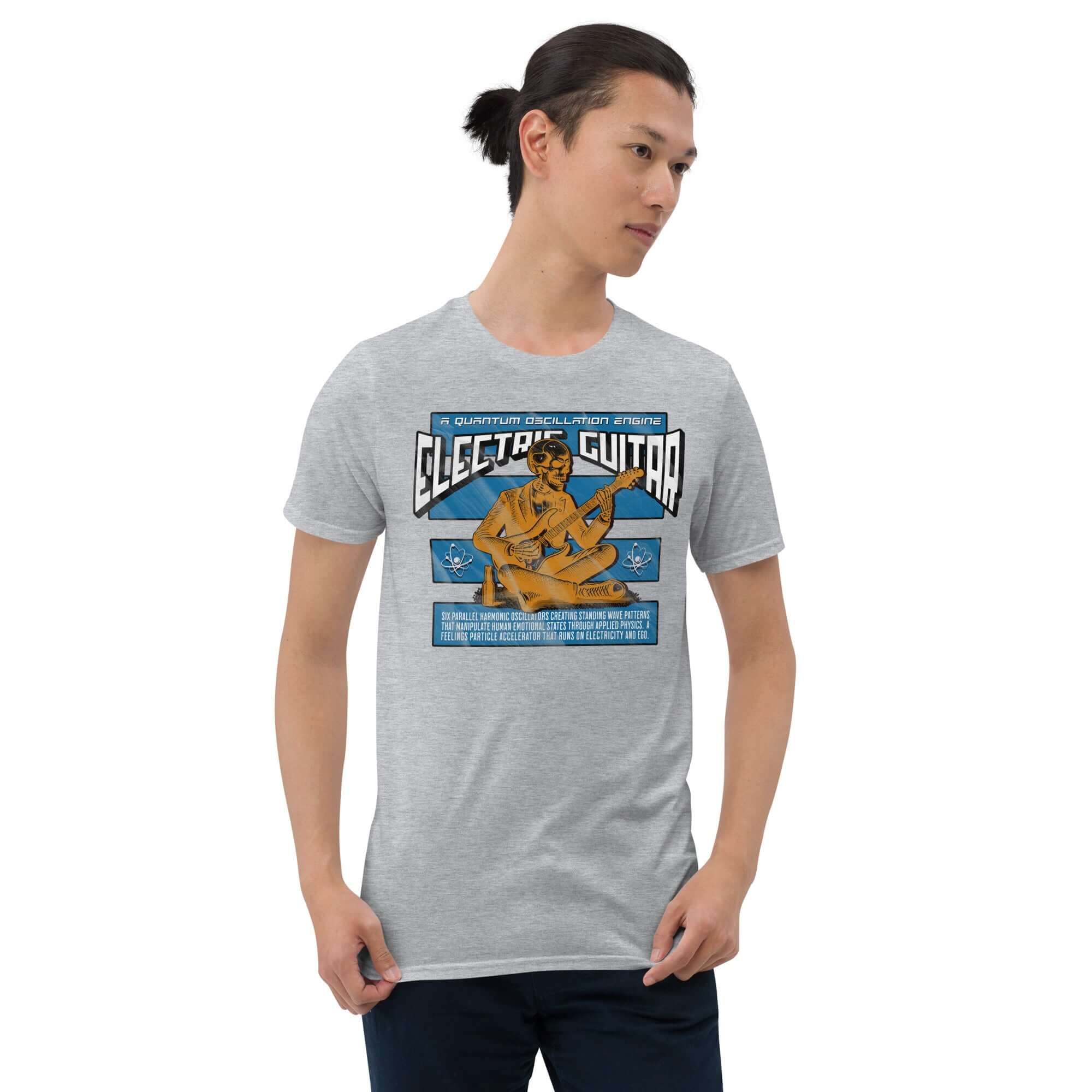 Man wearing a gray Electric Guitar Quantum Oscillation T-Shirt featuring physics and music humor design.
