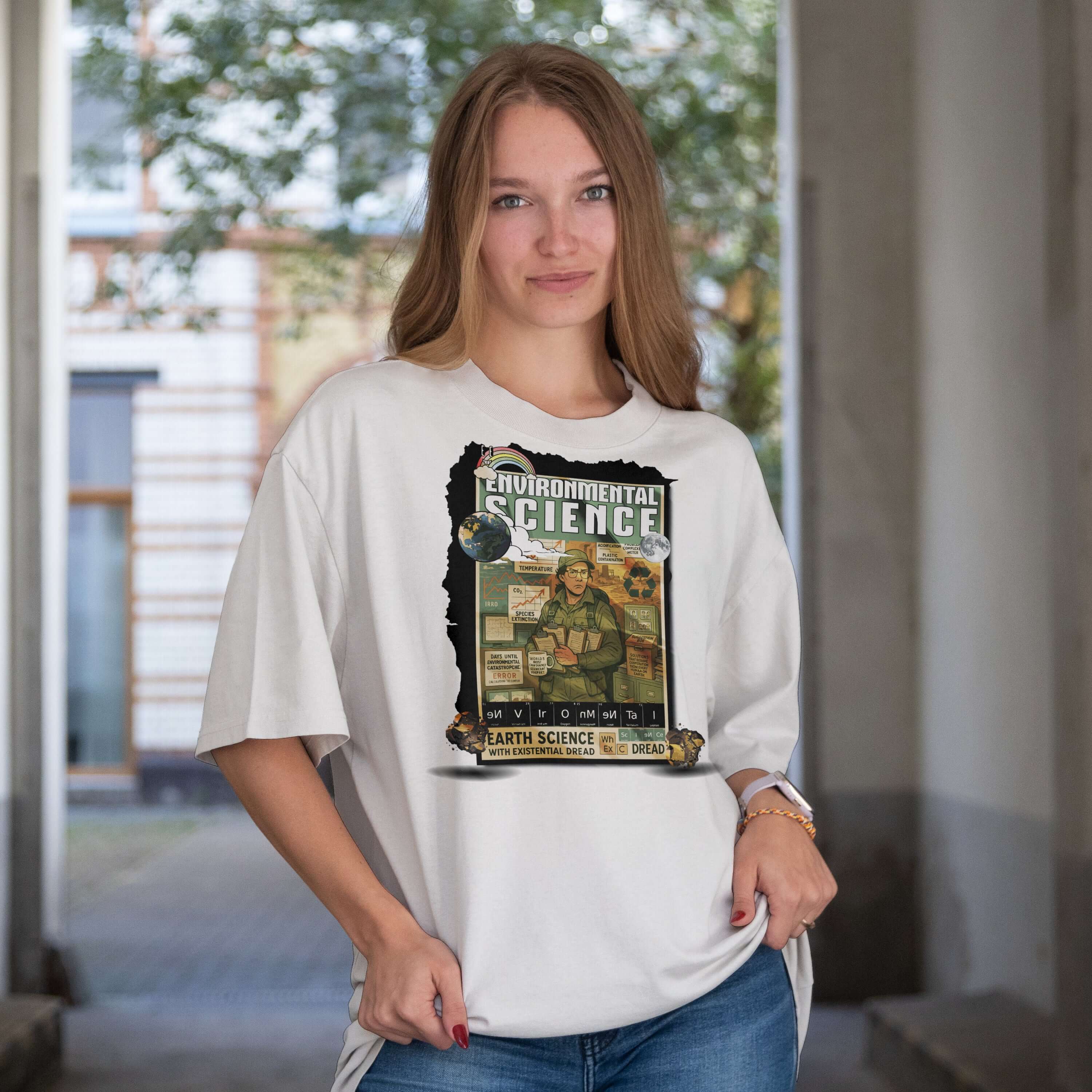 Smiling person wearing Environmental Science T-Shirt with Earth Science theme, standing in an outdoor passage.