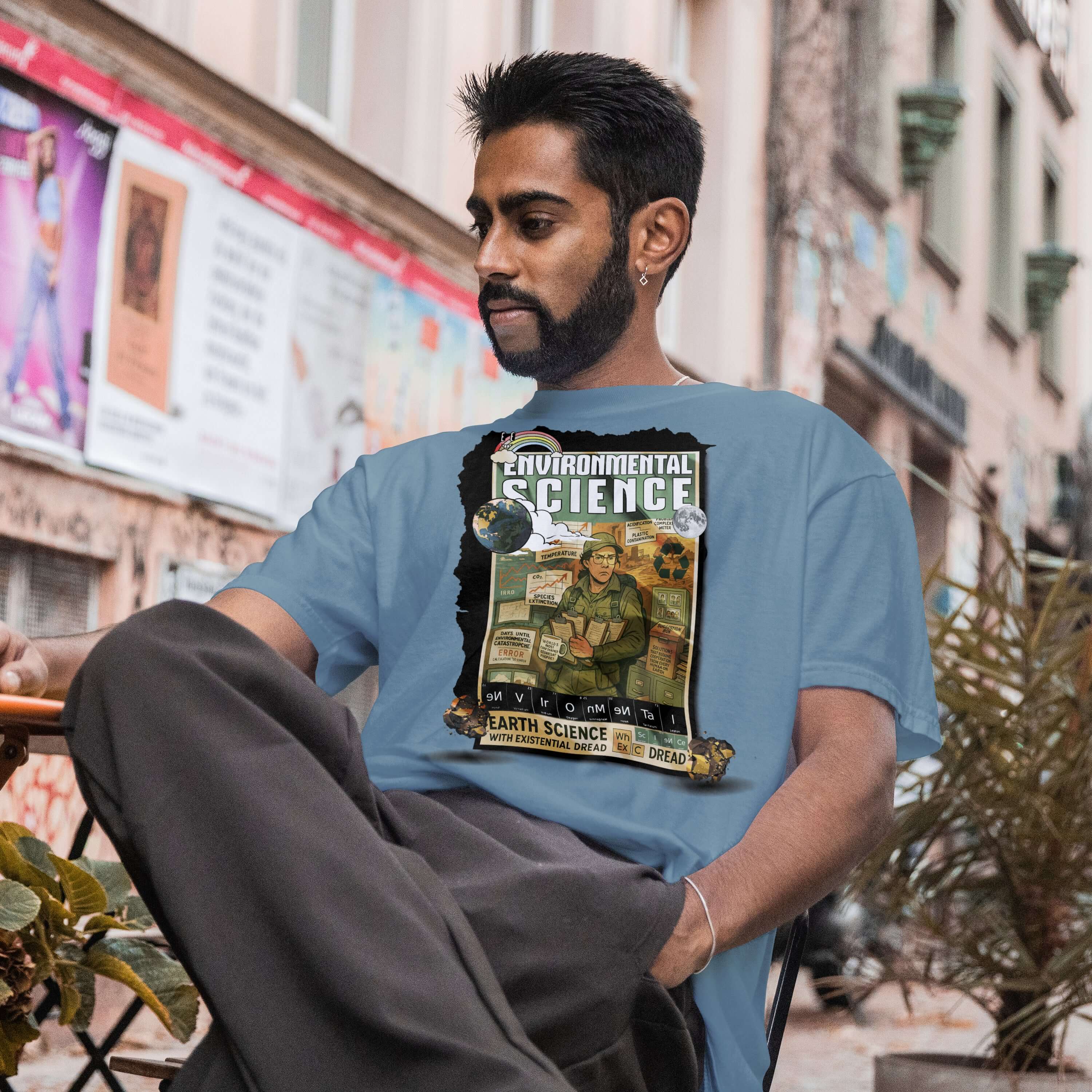 Person wearing Environmental Science T-Shirt with a design about Earth Science and existential dread, sitting outdoors.