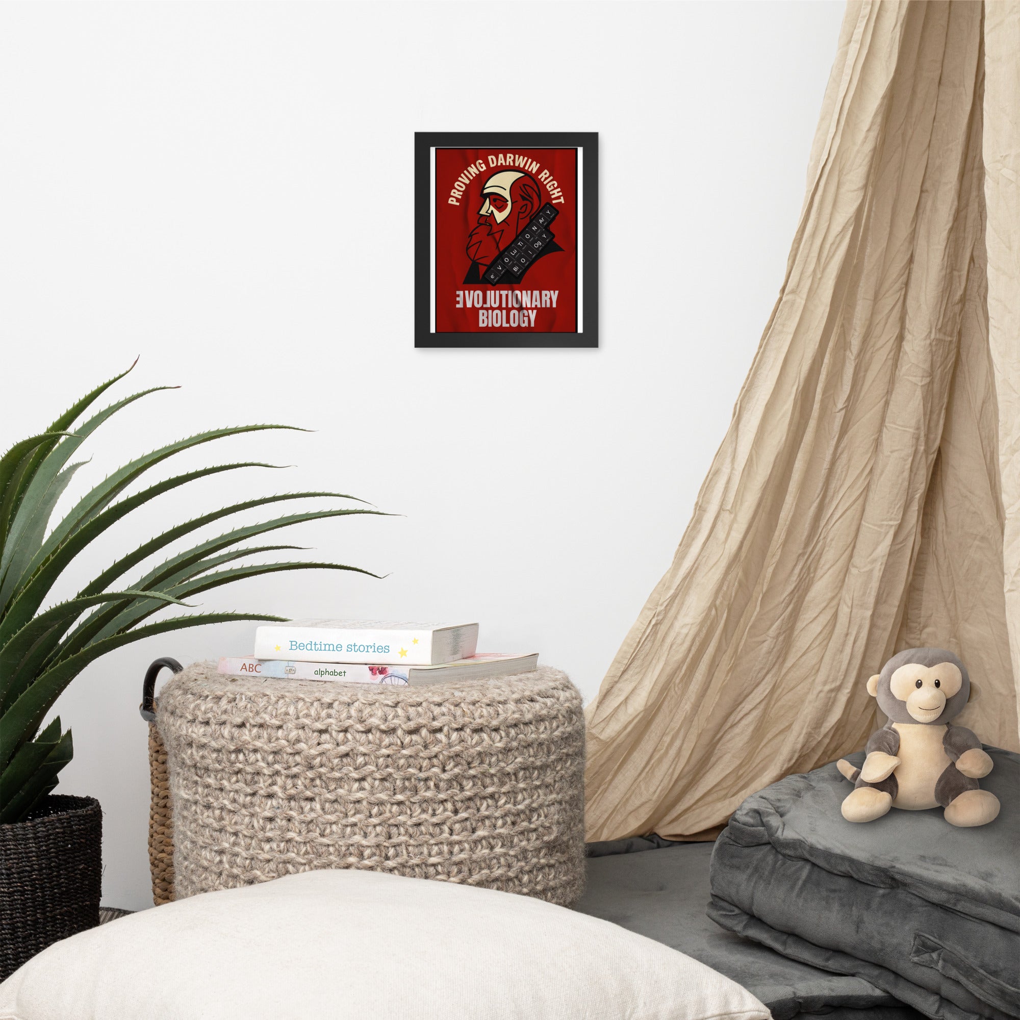 Evolutionary Biology wall poster framed on wall in cozy room with plant, reading books, basket, and stuffed monkey, celebrating Darwin.