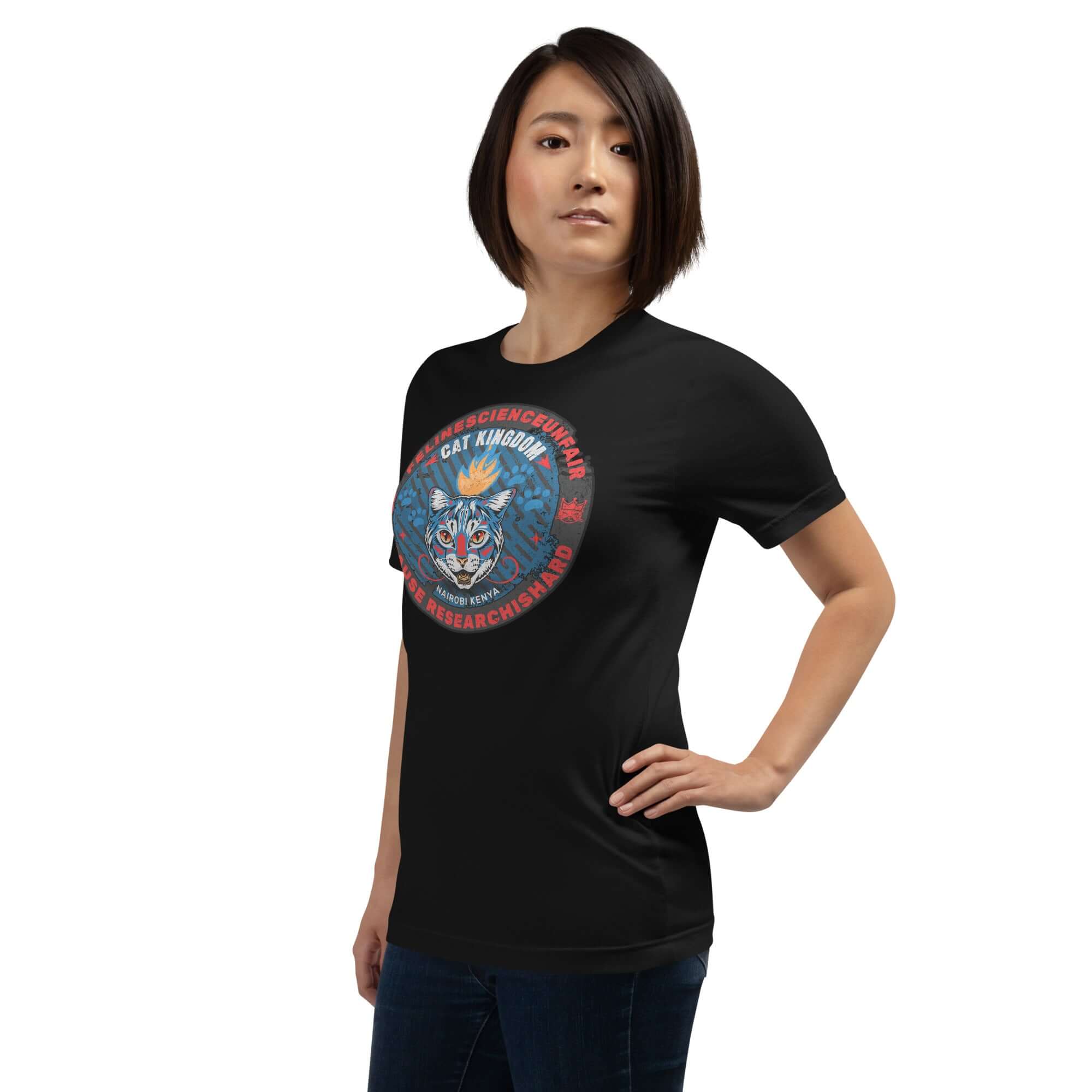 Woman wearing Feline Science Unit Cat Kingdom T-Shirt, black with wildcat design and blue pattern, for Nairobi research expedition.