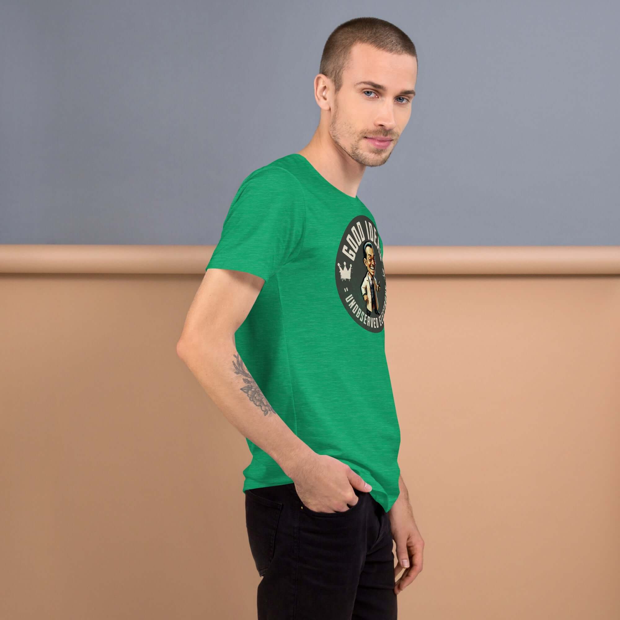 Man wearing Green 'Good Ideas Unobserved Electrons' T-Shirt, humorous quantum physics design with vintage illustration.