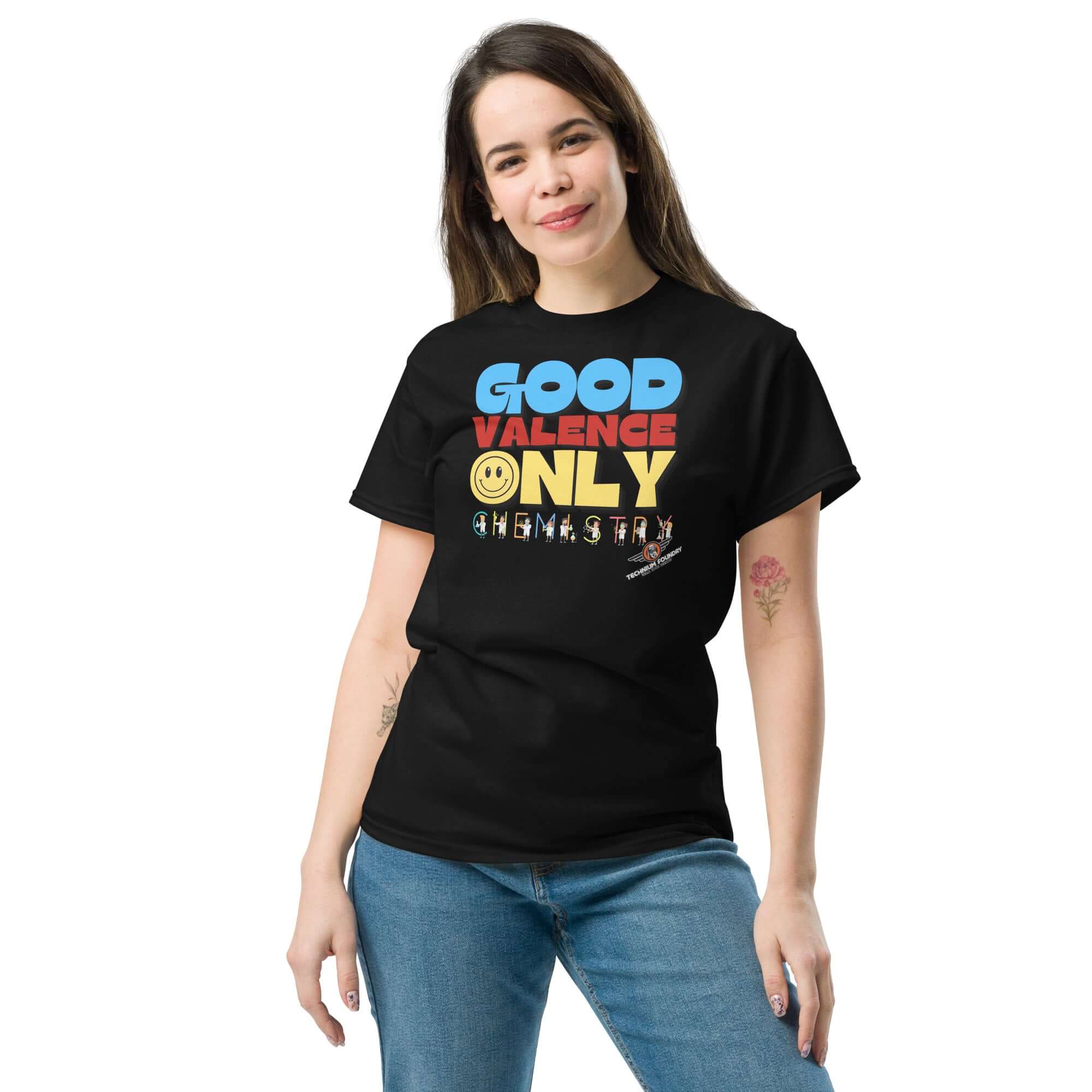 Woman wearing black "Good Valence Only" chemistry t-shirt with colorful lettering and lab scientist graphics.