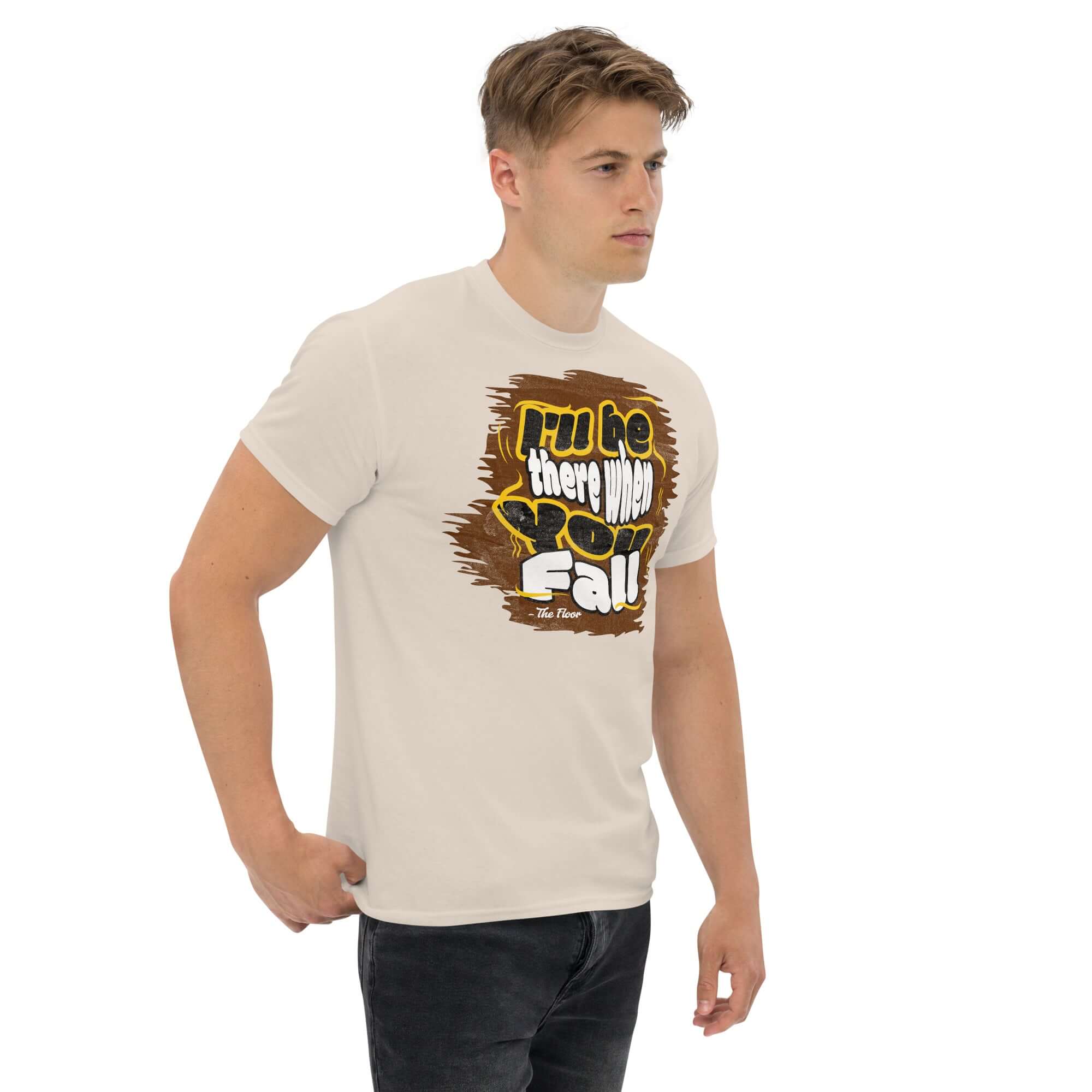 Model wearing 'I'll Be There When You Fall - The Floor' ironic quote t-shirt, showcasing humorous apparel.