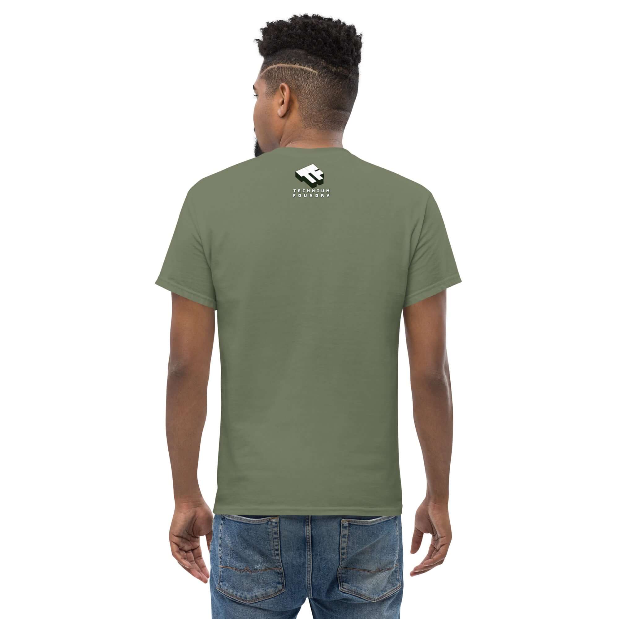 Man wearing a green t-shirt from the back, showcasing logo branding near the neckline.