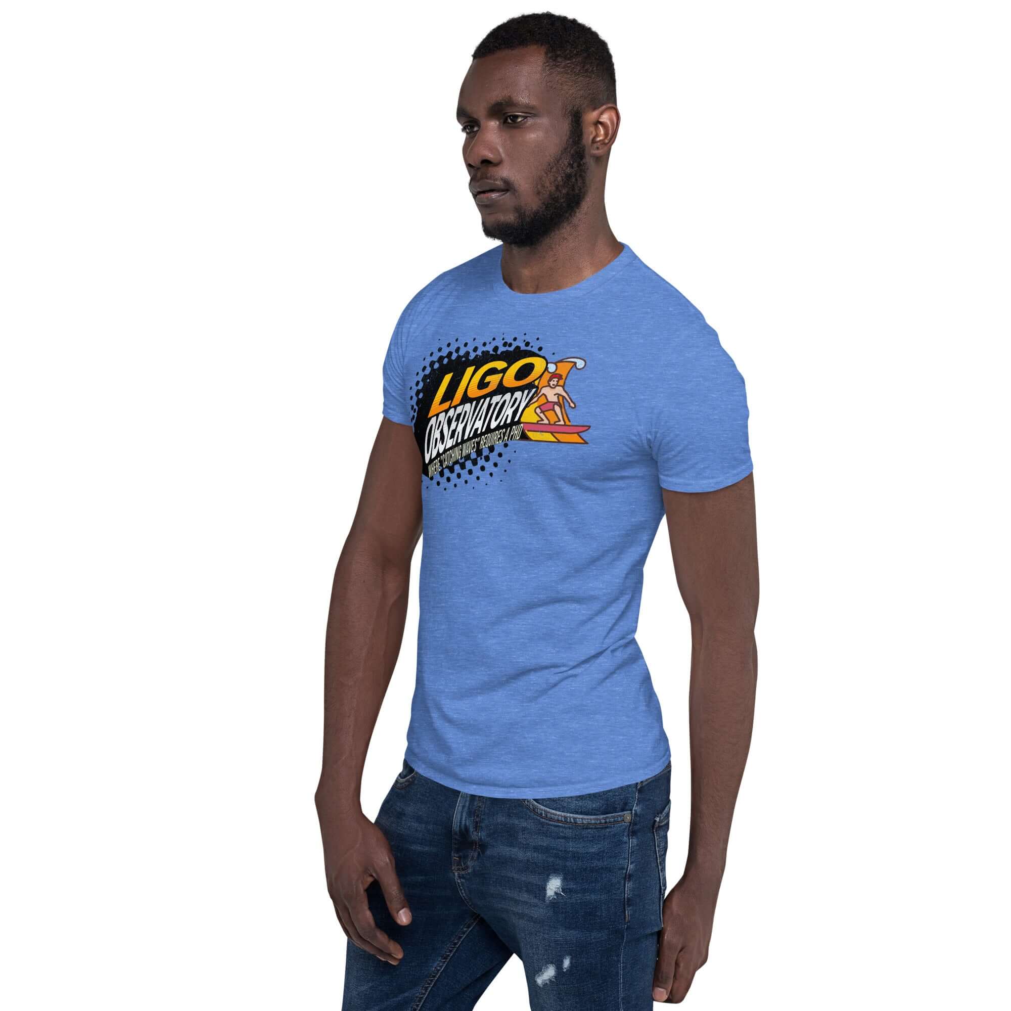 Model wearing a blue LIGO Observatory T-shirt with a yellow-to-orange gradient logo depicting cosmic wave hunting.