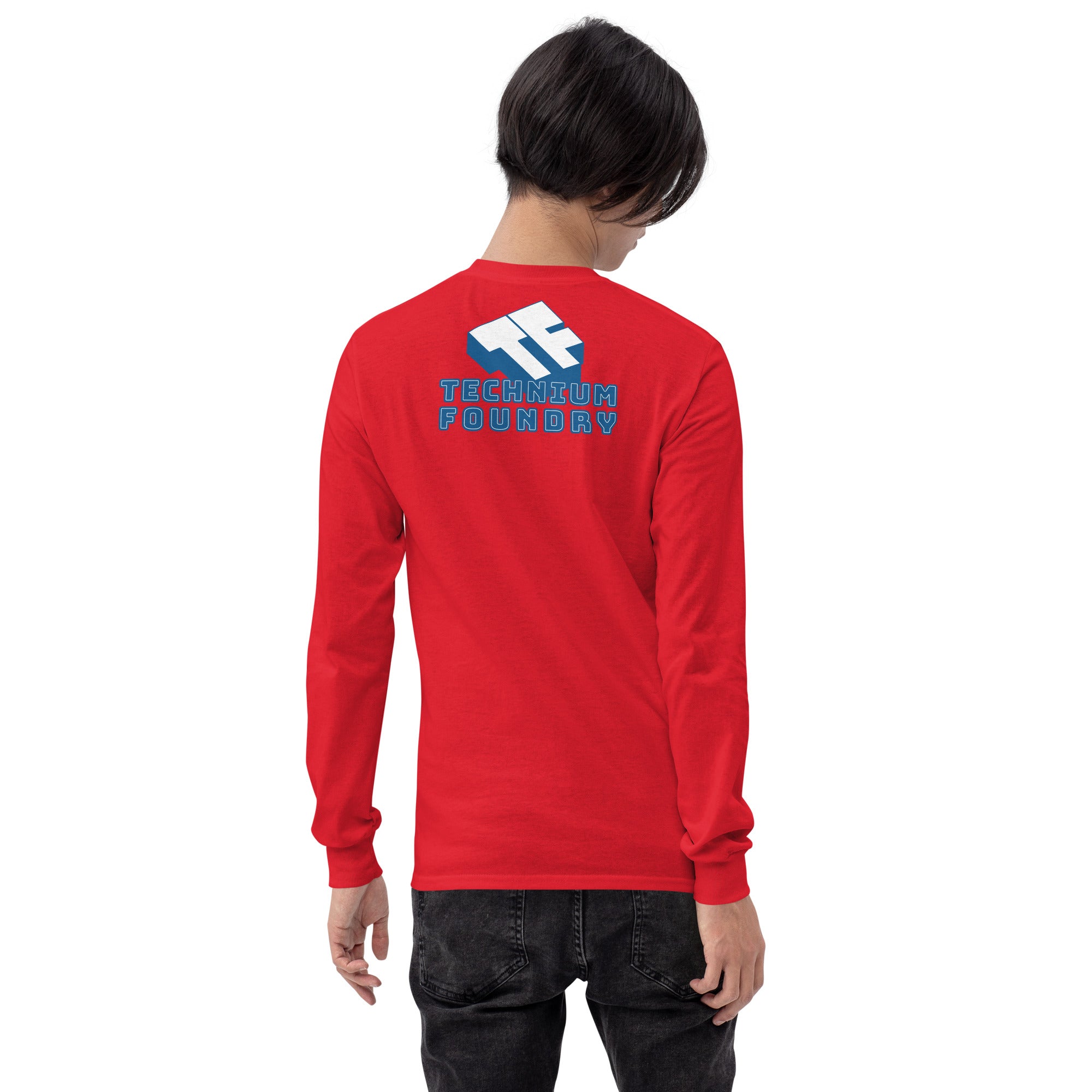 Person wearing a red long sleeve shirt with "Technum Foundry" text and logo on the back.