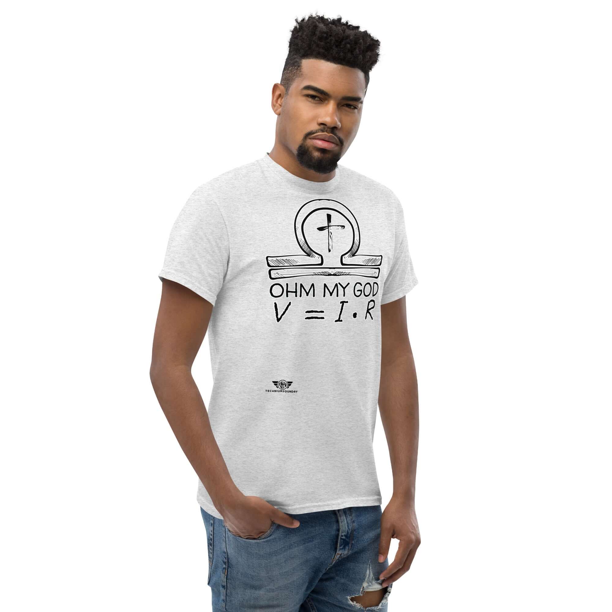 Man wearing 'Ohm My God' T-shirt with Ohm's Law and ankh-omega symbol design, blending physics and religious humor.