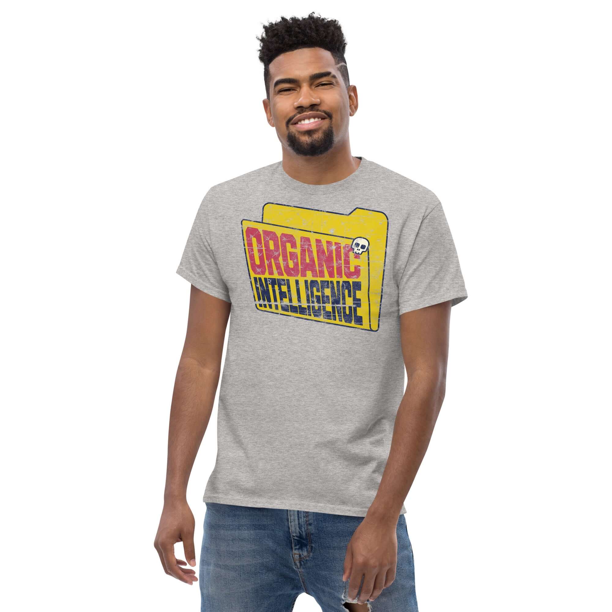 Man wearing Organic Intelligence T-shirt with anti-AI humor, featuring a vintage computer folder design against AI technology.