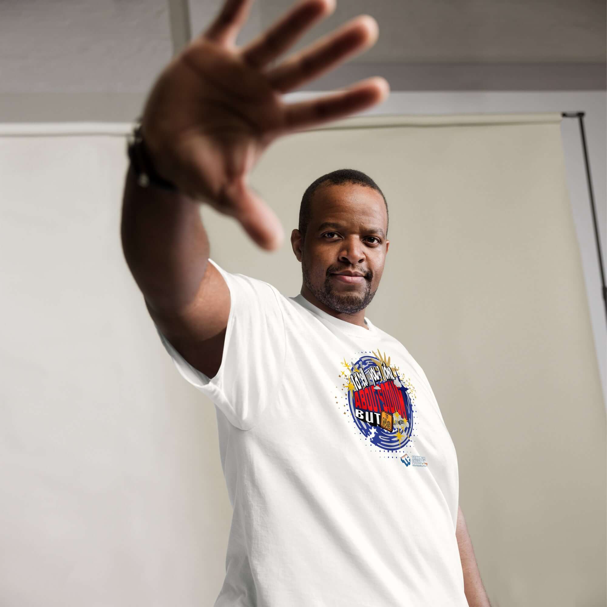 Man wearing Sodium Chemistree Joke T-Shirt with cosmic blue swirl design, showcasing periodic table humor and science pun.