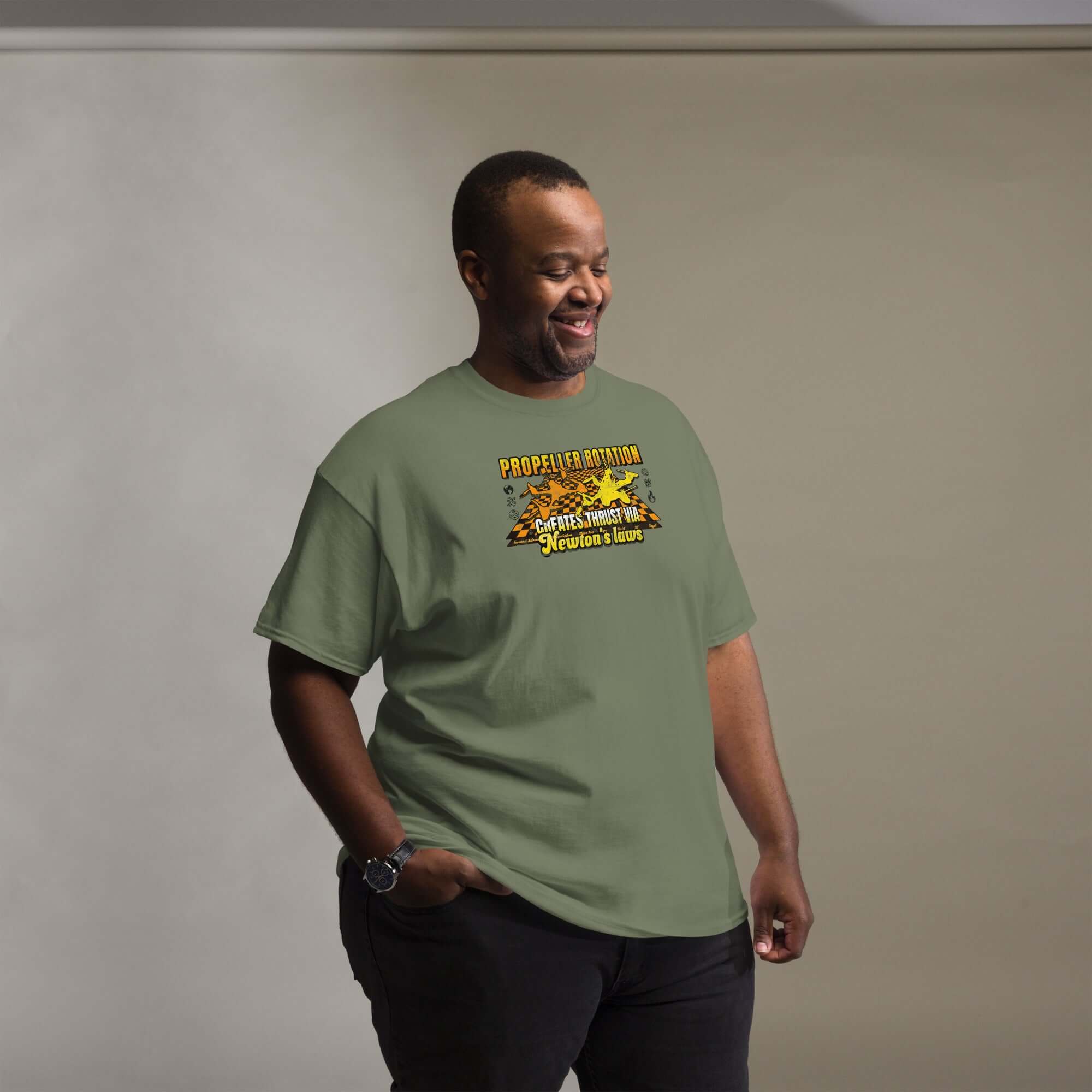 Man wearing Propeller Rotation Physics T-Shirt highlighting drone science and Newton's laws against beige background.