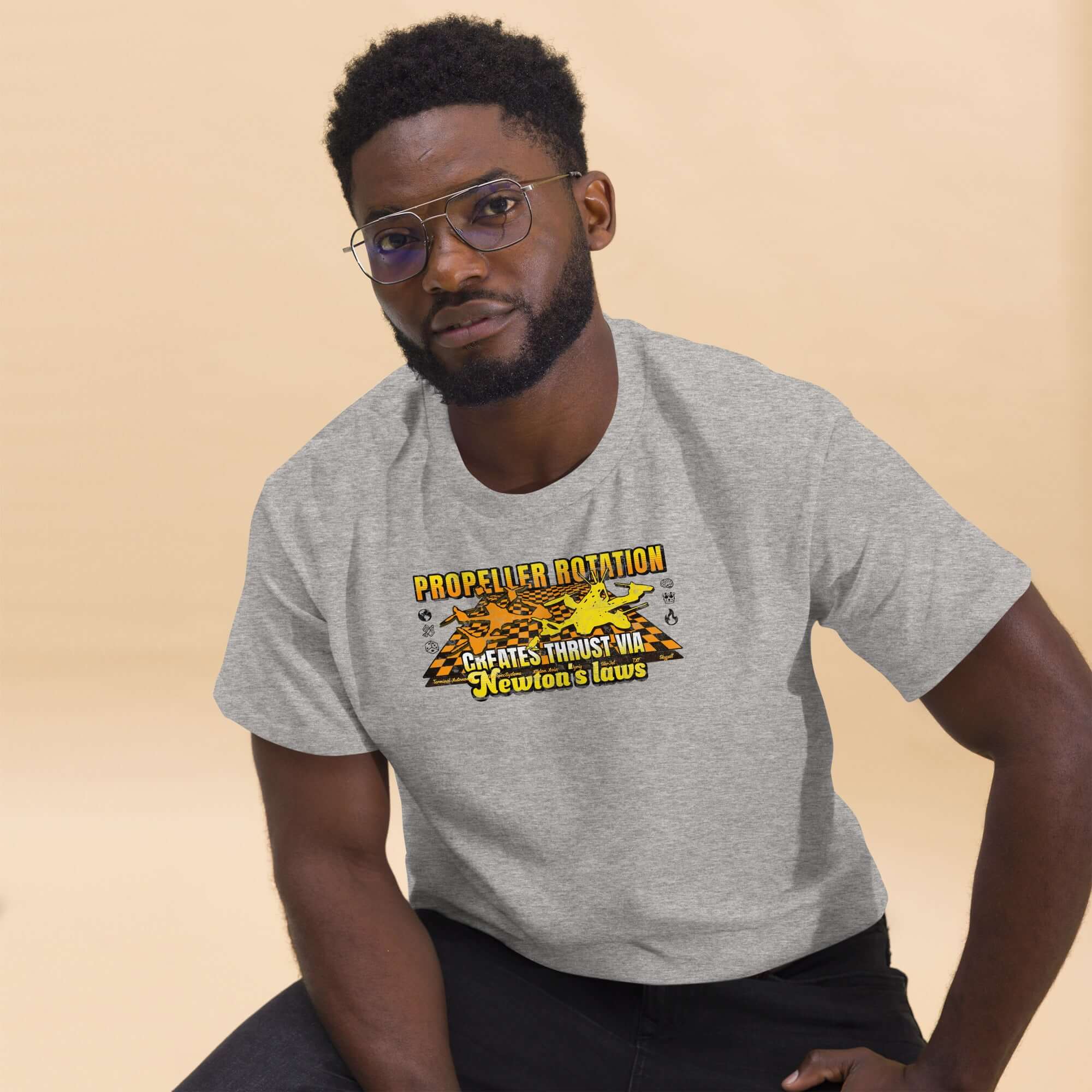 Man wearing Propeller Rotation Physics T-Shirt with drone science design, embodying Newton's Laws and aerodynamic style.