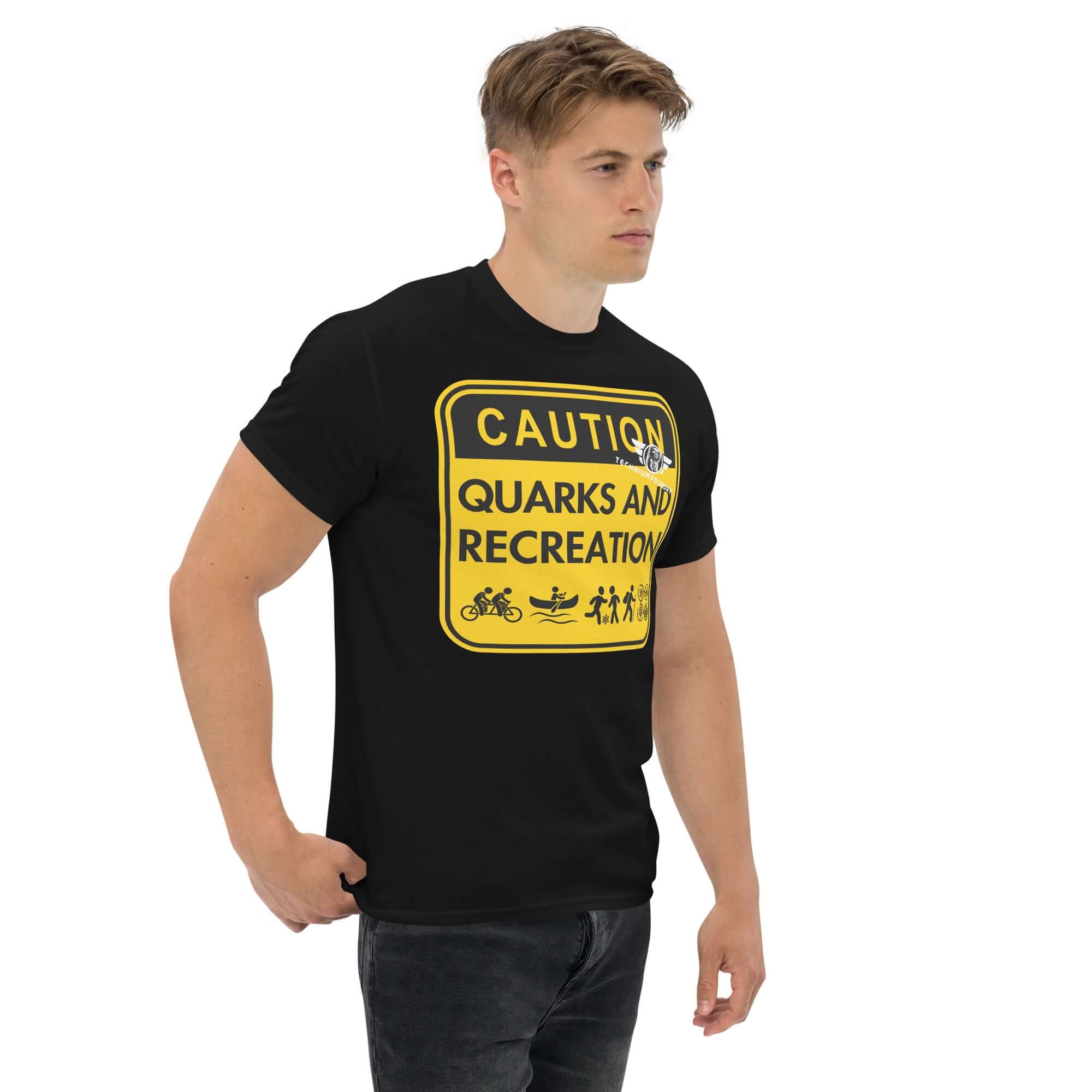 Man wearing "Quarks and Recreation" t-shirt with physics-themed warning sign design in yellow and black.