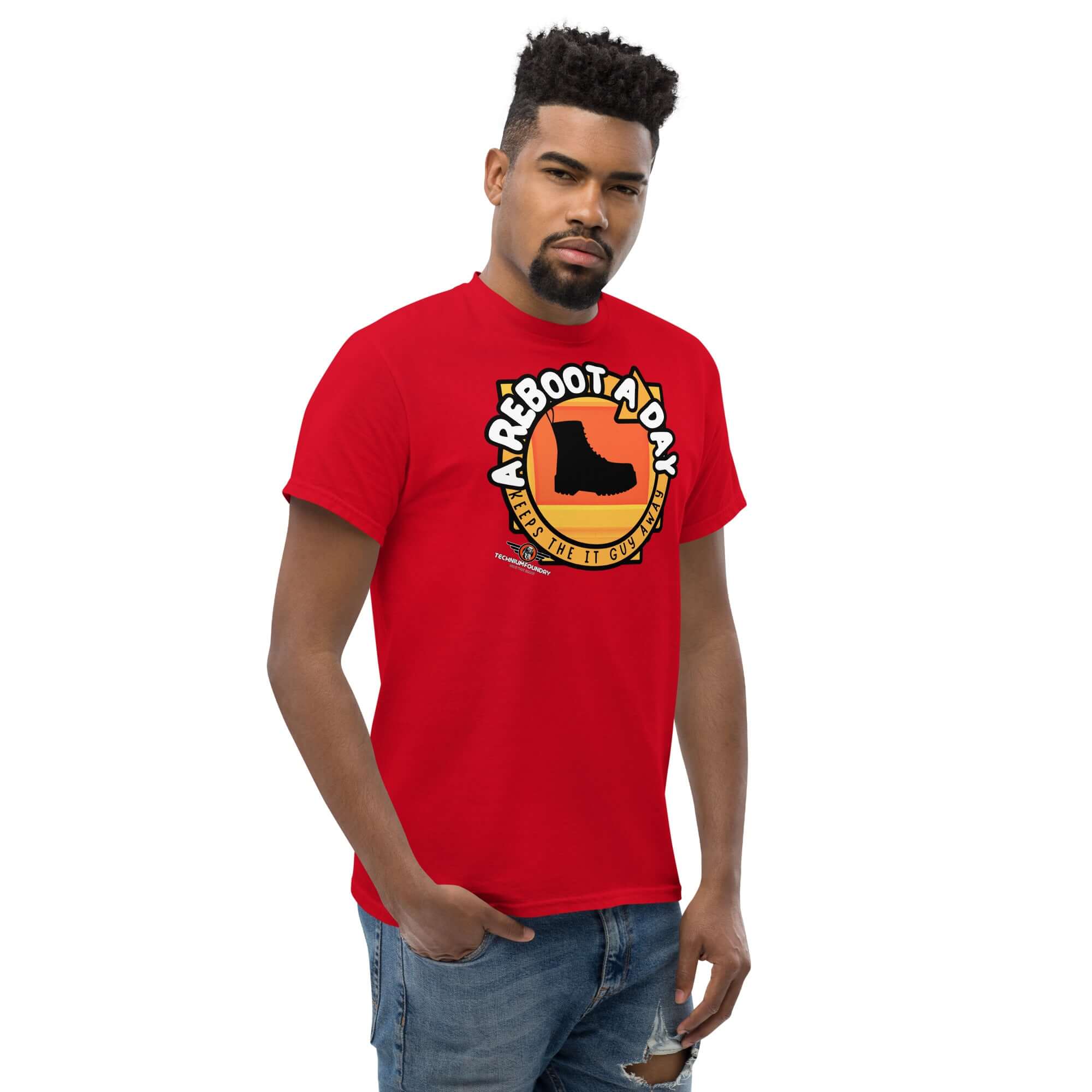 Man wearing "A Reboot A Day" IT support humor t-shirt with boot design on red background, celebrating tech support solutions.