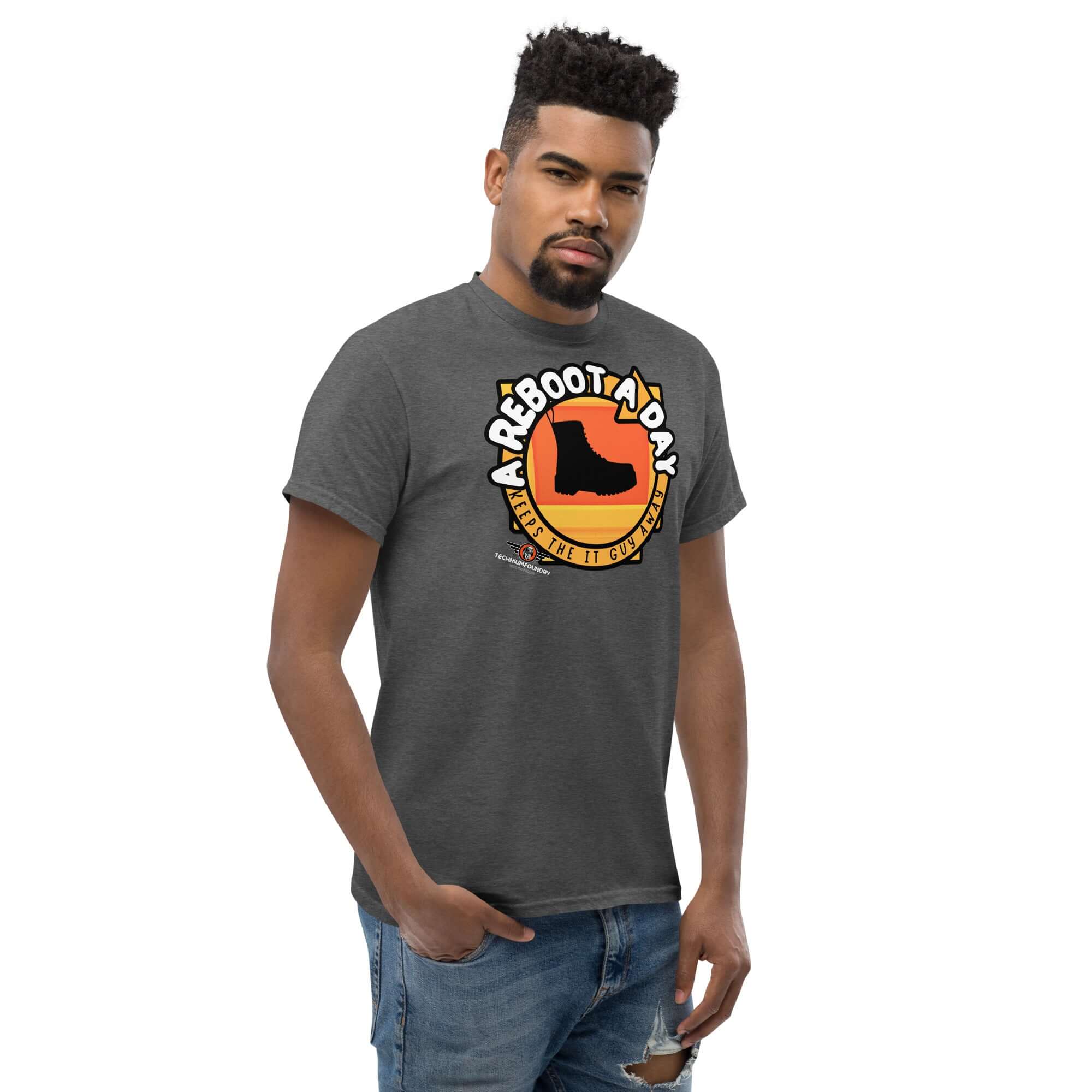 Man wearing 'A Reboot A Day' IT support humor t-shirt with boot design on gray fabric.