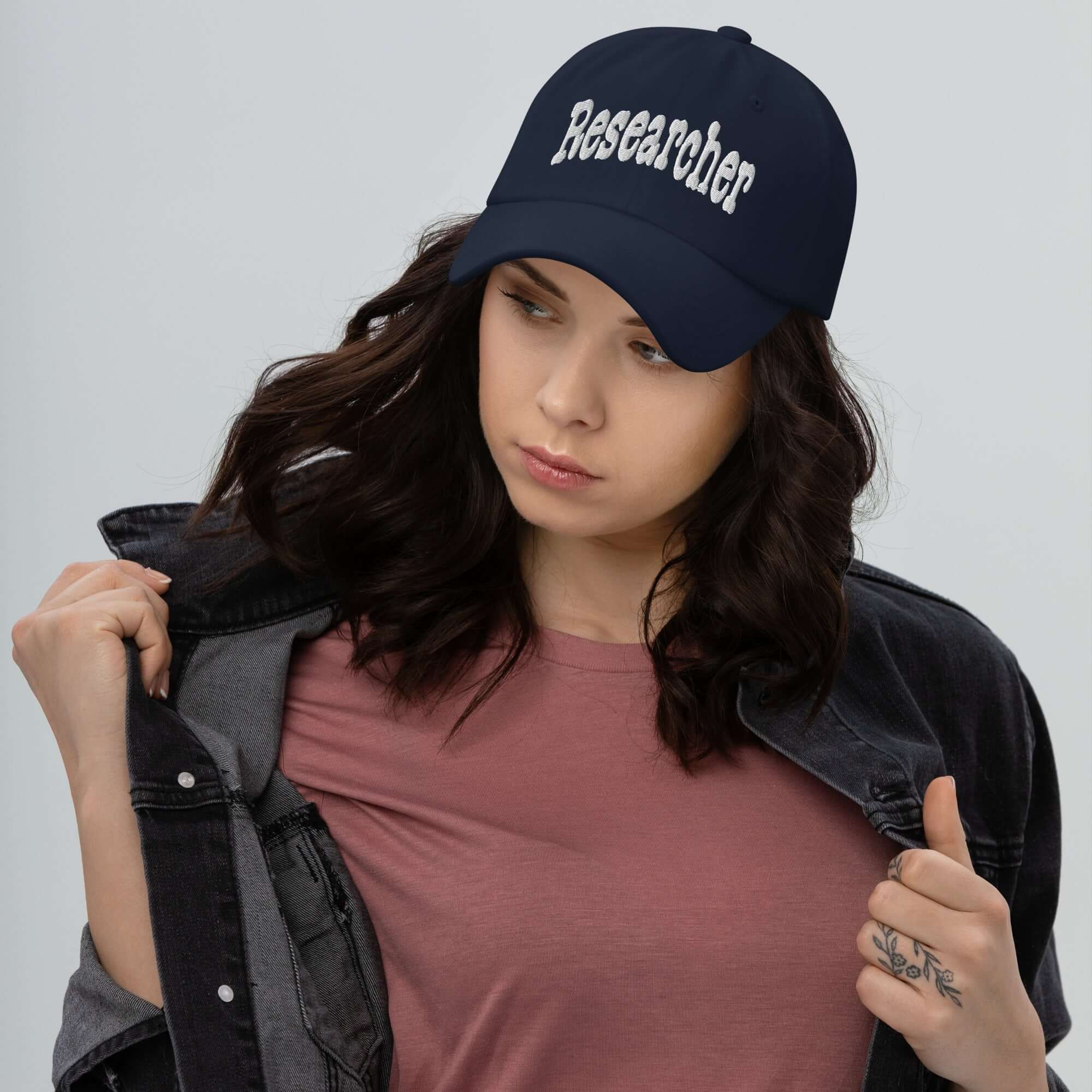 Person wearing 'Researcher' baseball cap, symbolizing professional curiosity and scientific inquiry.
